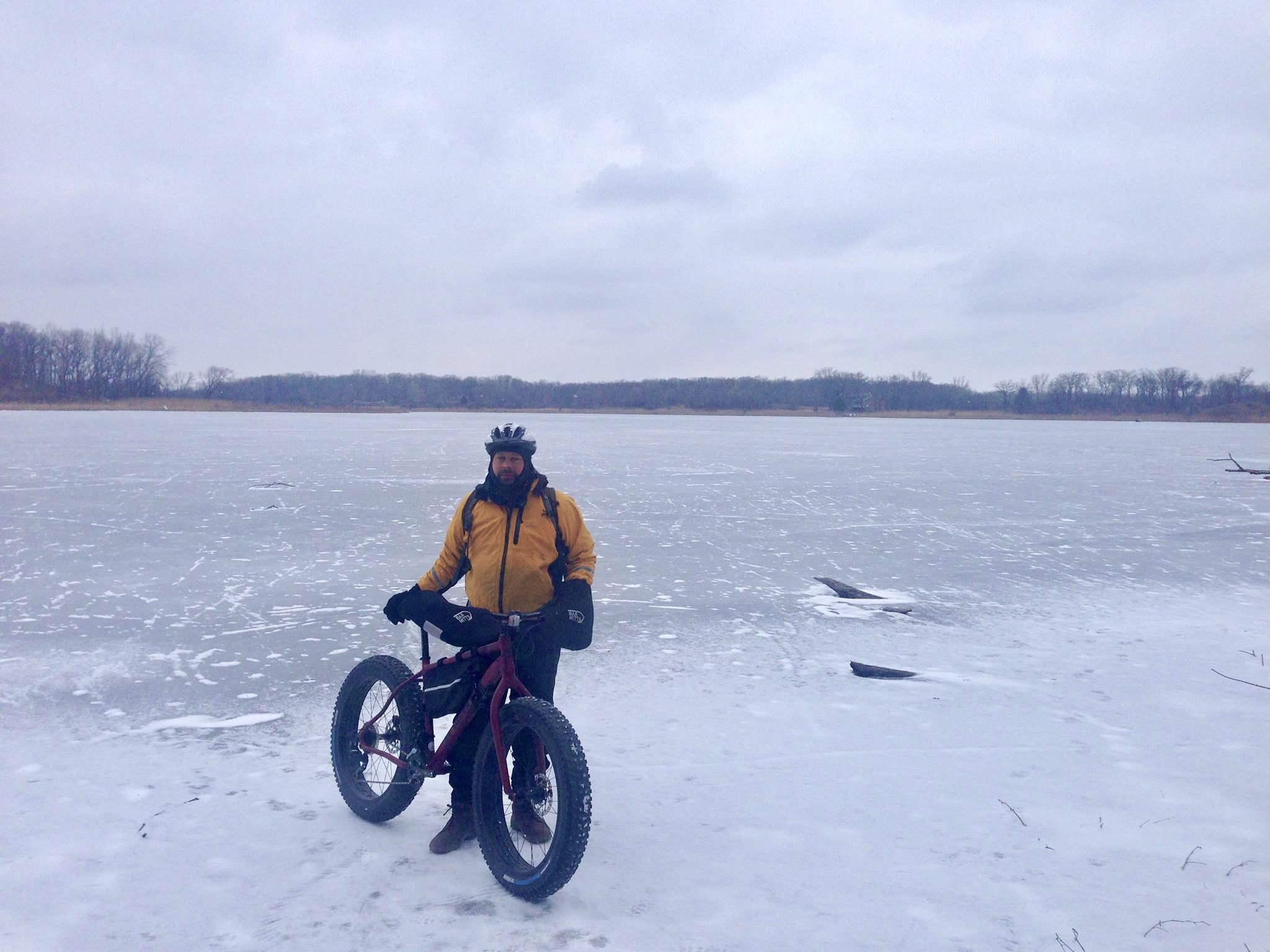 Man with fatbike on frozen lake