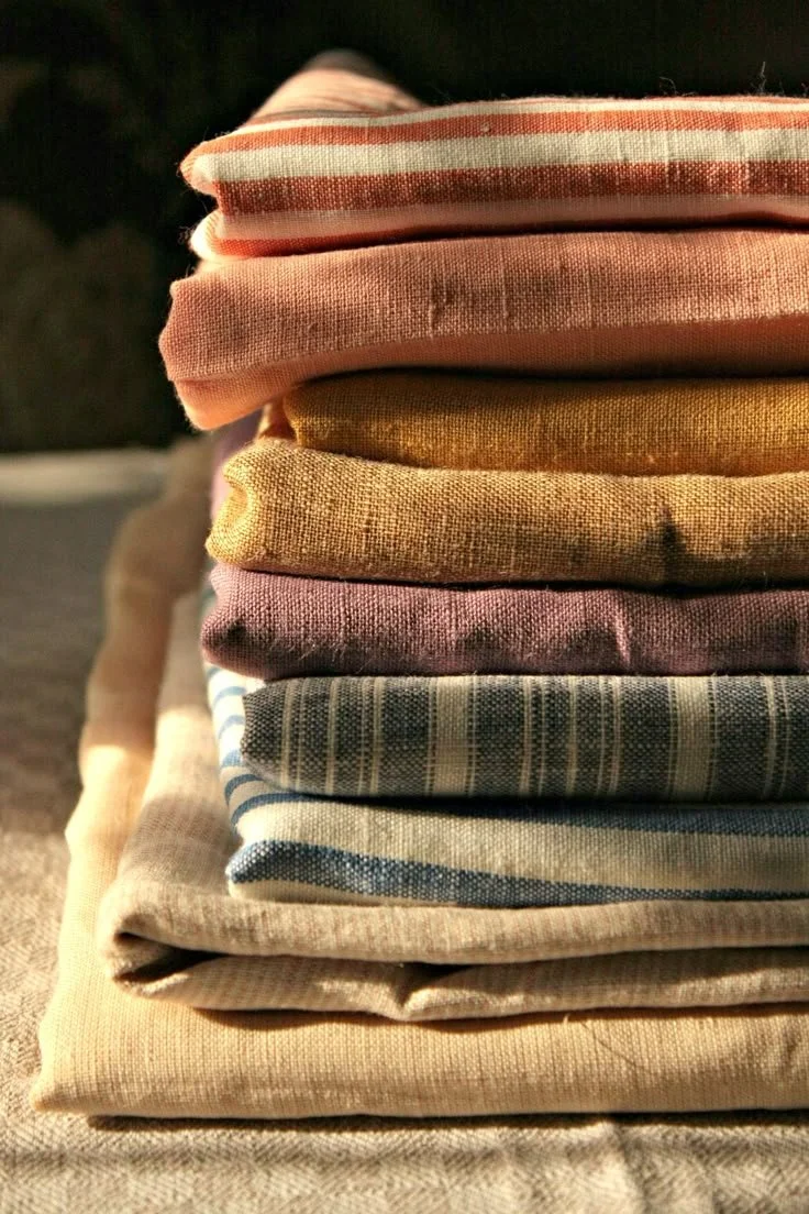Stack of folded, multicolored cloths or towels.