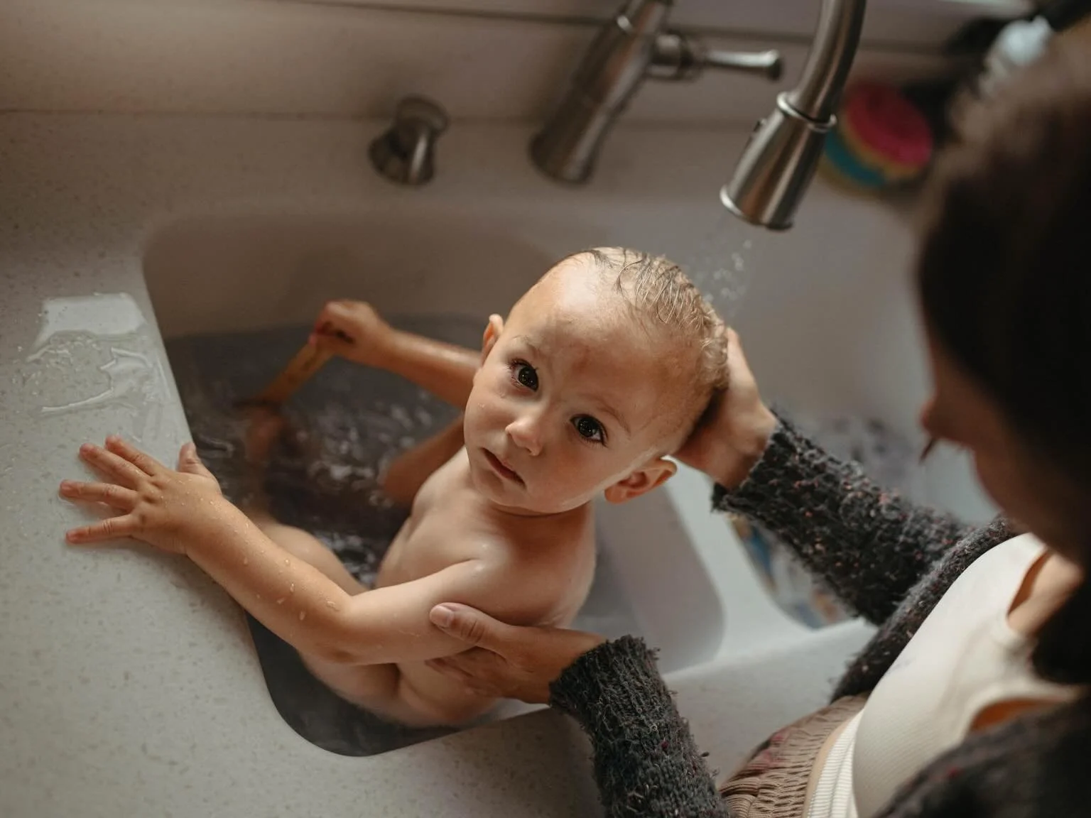 Like little scenes from your own home videos.

The moments always end up meaning the most.

Kitchen sink baths. Crayon drawings on the windows. Nursing your babies in the quiet corners of your home. Bare feet on the windowsill. The way your children 