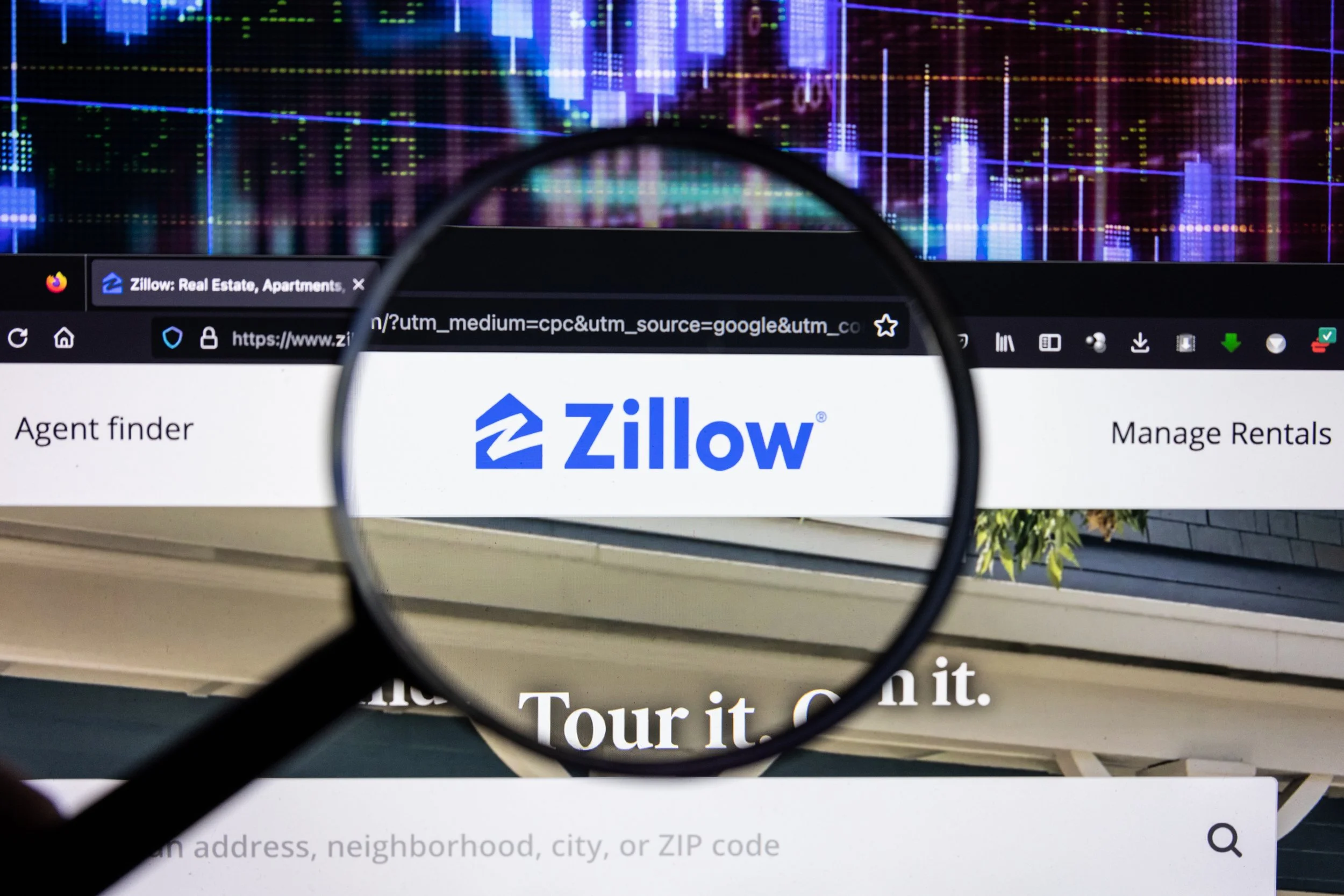 Close-up of a computer screen showing the Zillow website, with a magnifying glass emphasizing the Zillow logo, and a background of colorful financial charts.