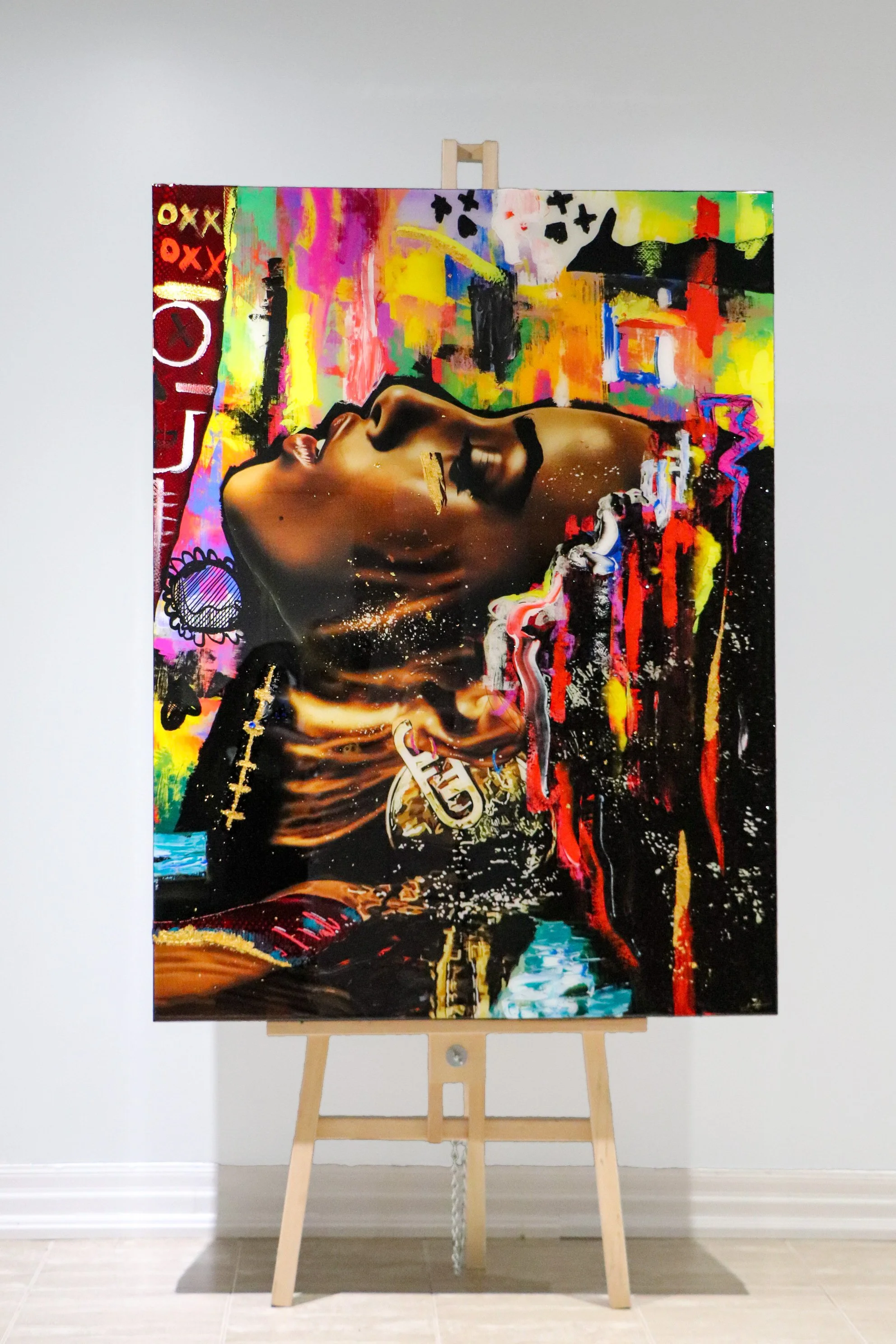Colorful abstract painting on canvas featuring a side profile of a woman's face with closed eyes and bold makeup, set against a vibrant background of graffiti-inspired elements and bright colors.