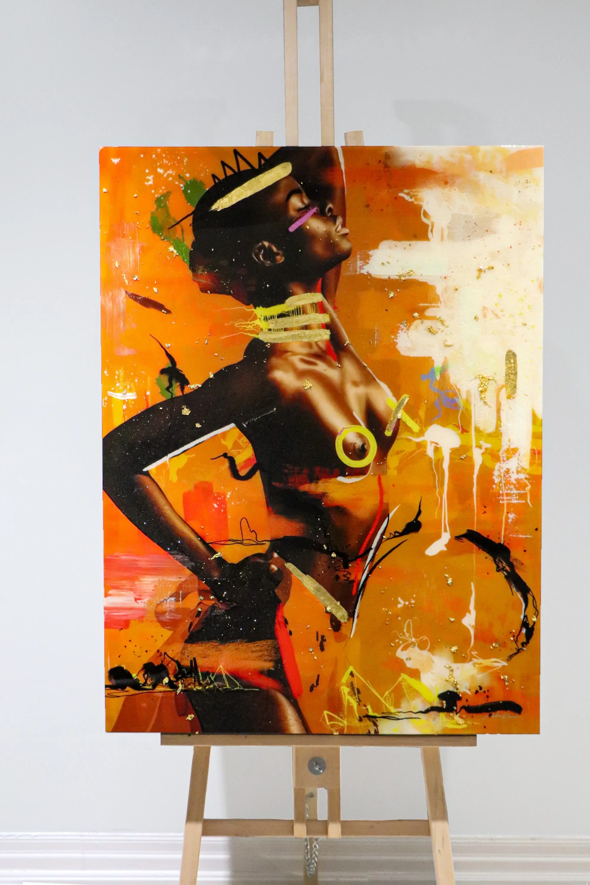 Abstract art piece featuring a stylized portrait of a woman with dark skin, adorned with gold and black accessories, against an orange background with splashes of color and graffiti-like elements.