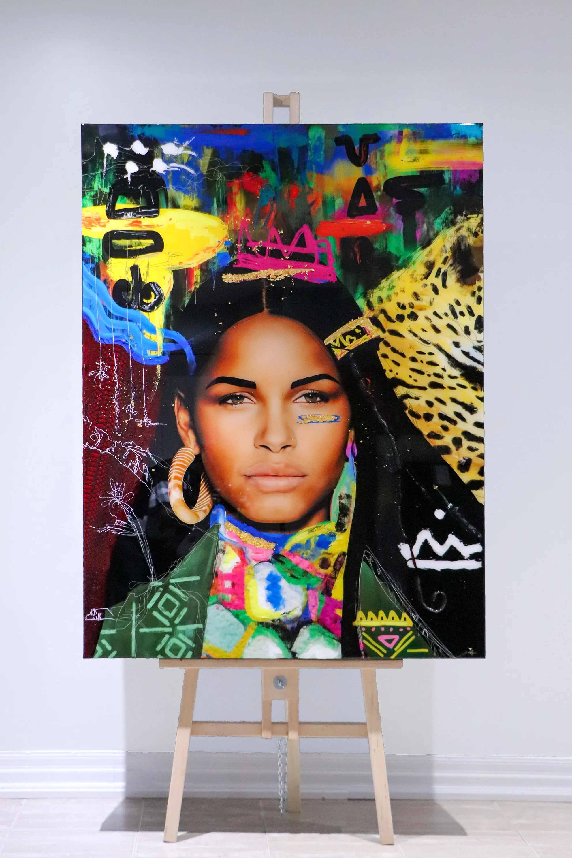 A colorful mixed-media portrait of a woman with braided hair, earrings, and vibrant jewelry, set against a background with abstract graffiti and animal print patterns.