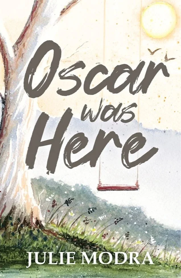 Book cover for 'Oscar was Here' by Julie Modra, featuring a tree, grass, a swing, a sun, and birds.