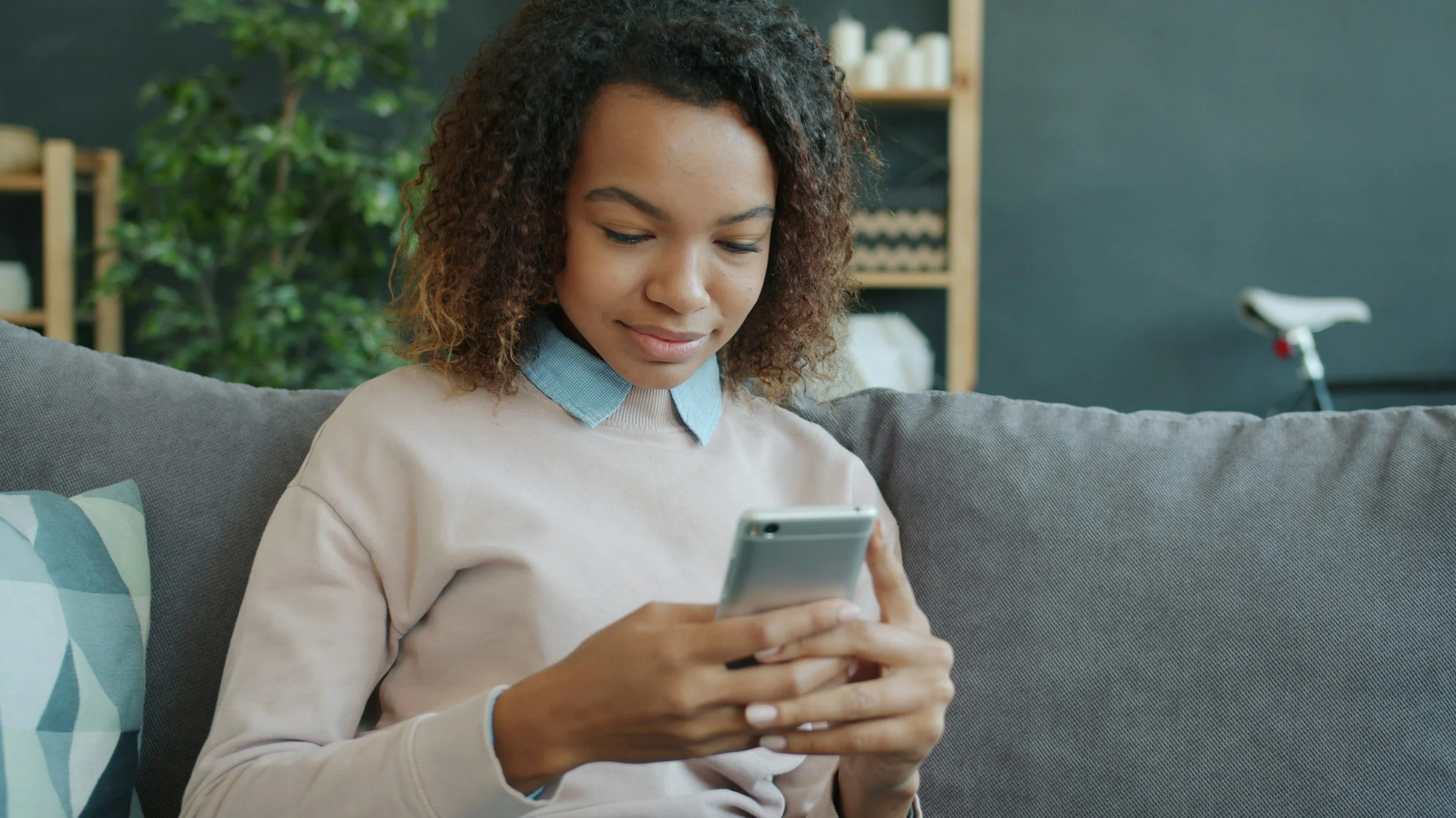 Private pay therapy client reading on her phone and finding a specialist therapist who gets her