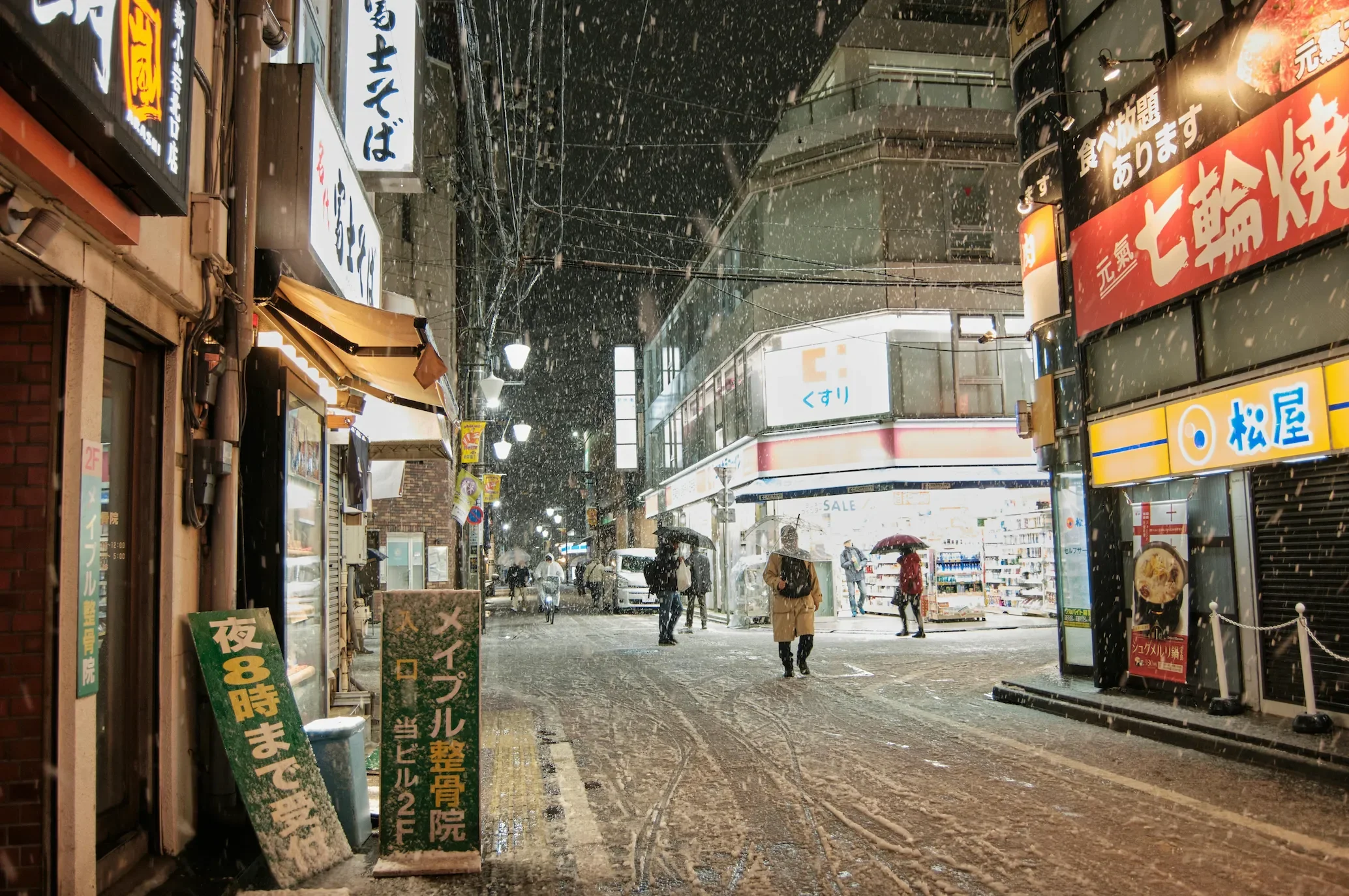 Snow falling on a vibrant Tokyo street at night with glowing neon signs, capturing the atmosphere of urban winter travel and international adventure.