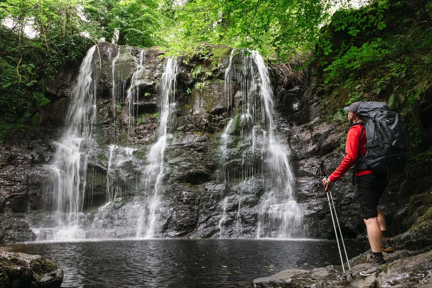 Hiker at Ess-Na-Crub Waterfall in Glenariff