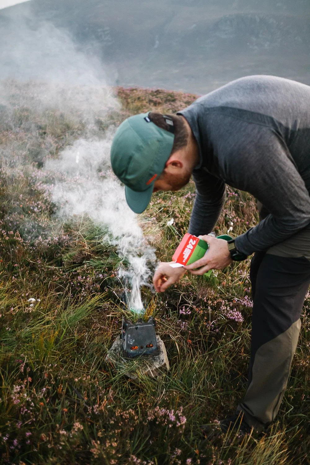 Stephen J Reid lighting a smoky camp fire