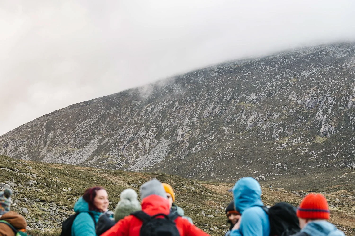 View in Mourne mountains with social group hikers in foreground