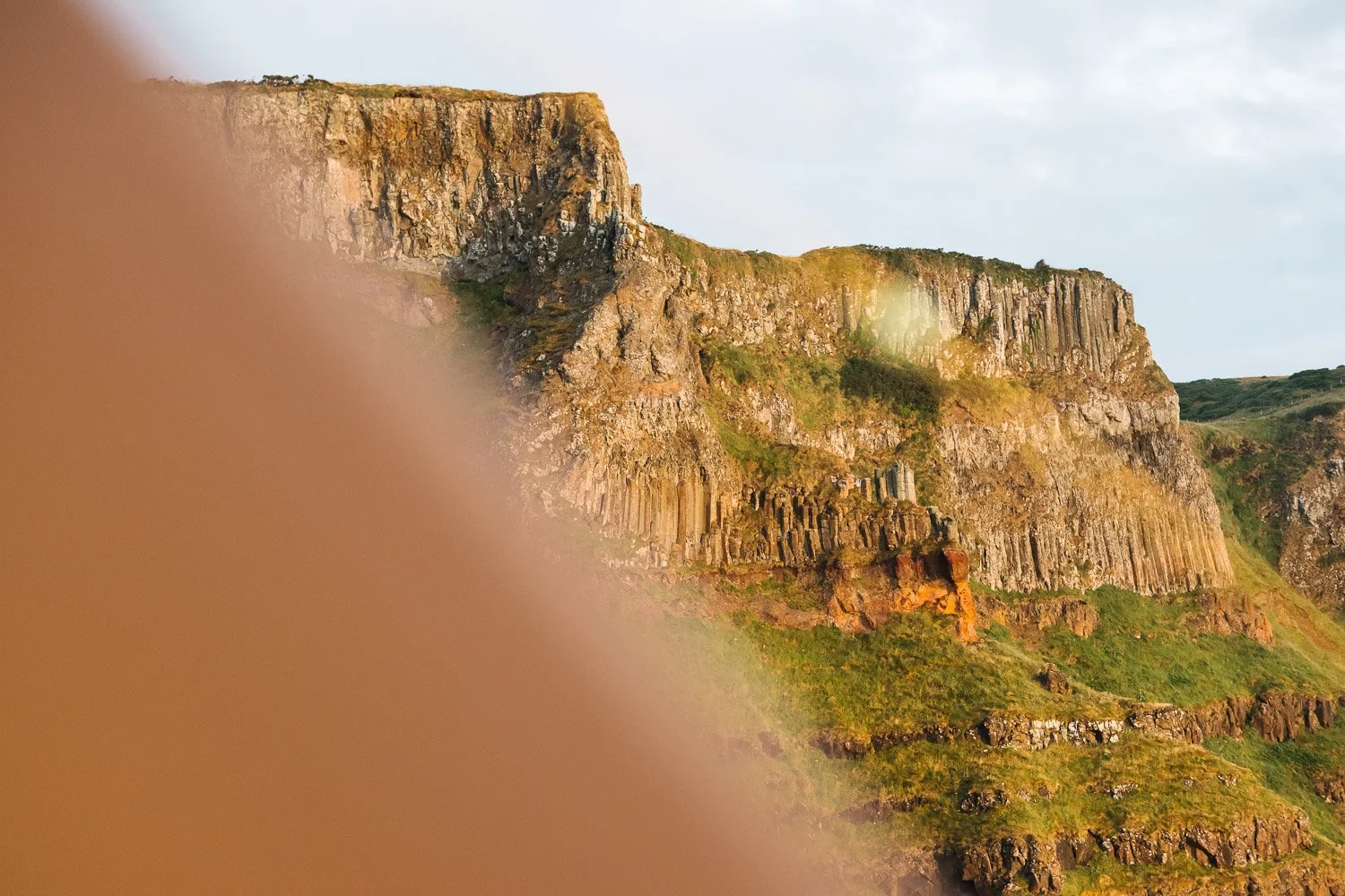 Causeway Coast cliffs lit by the sunrise