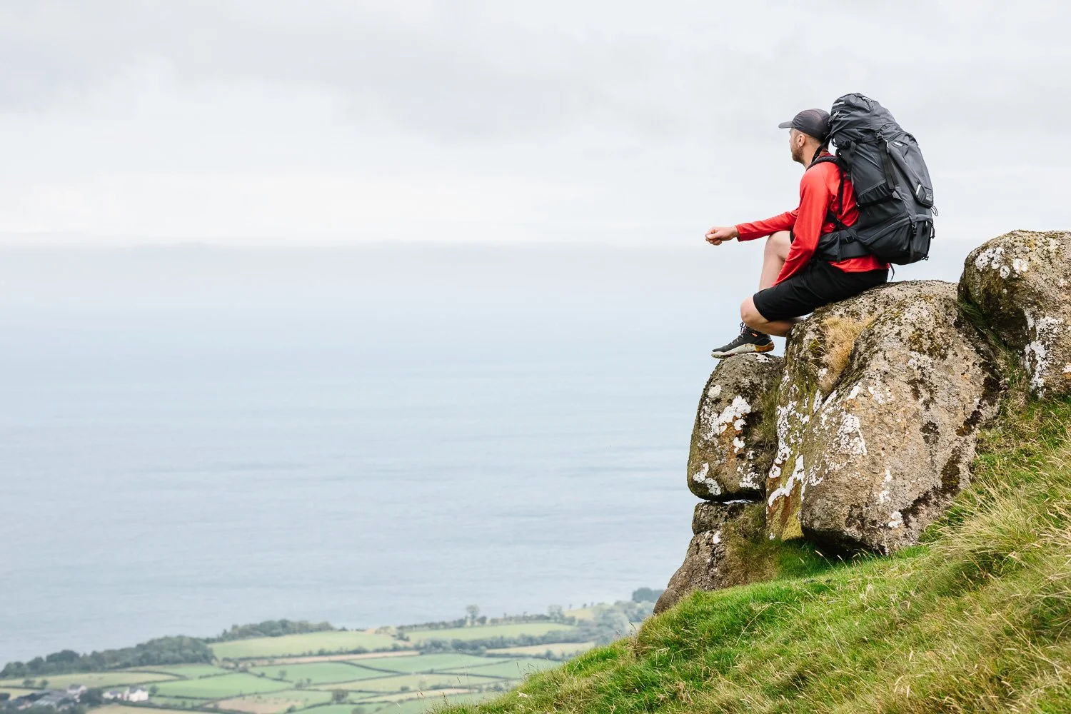 Hiker admiring view on Scawt Hill in the Antrim Hills