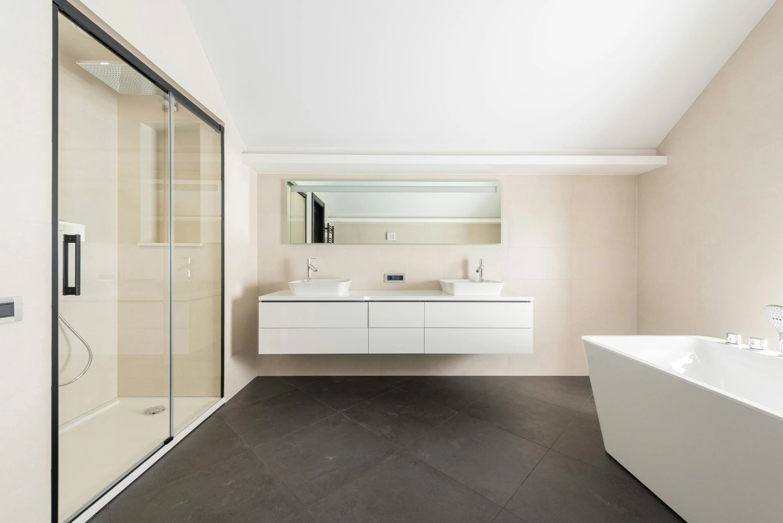 Modern bathroom with a shower, double sink vanity with mirror, and a bathtub.
