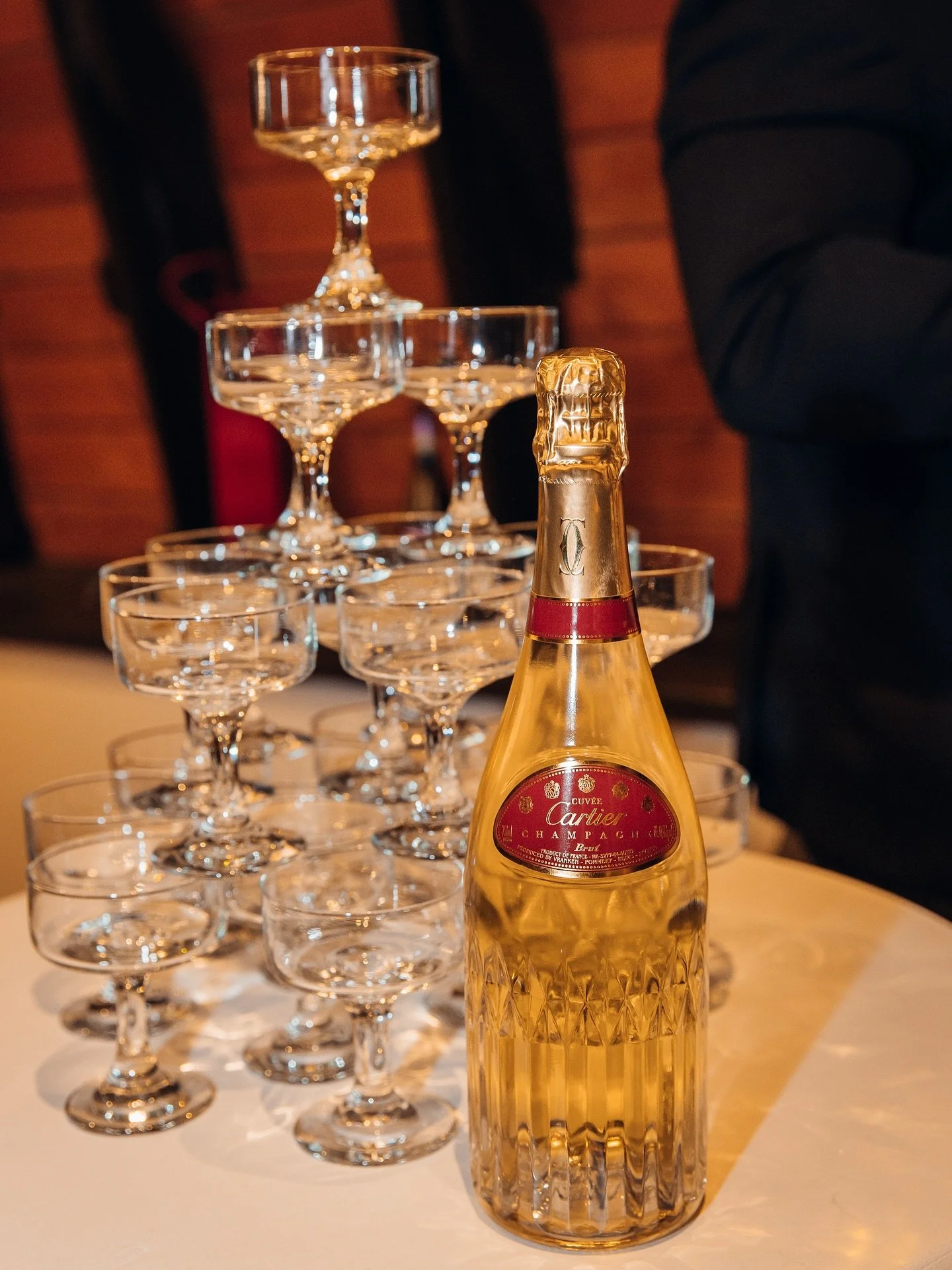 There&rsquo;s something about a champagne tower that transforms the whole room. As soon as the first pour started, everyone lit up &mdash; laughter, cheers, and that collective &ldquo;this is iconic&rdquo; energy.
From behind the camera, it felt like