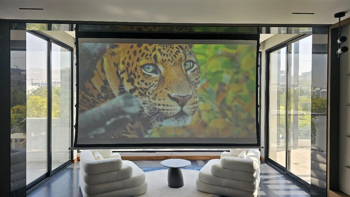 Glazed high-floor lounge with projection screen in a Dubai apartment