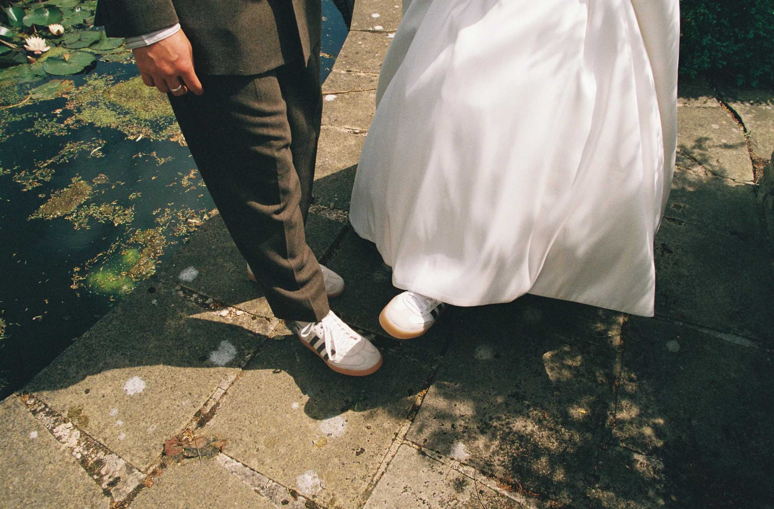 Elizabeth Royse Photography creates wedding imagery that feels cinematic and tactile with a mix of grainy film textures, bold direct flash, and intimate framing that captures fleeting moments like a bride feeding a horse at golden hour, a chandelier 