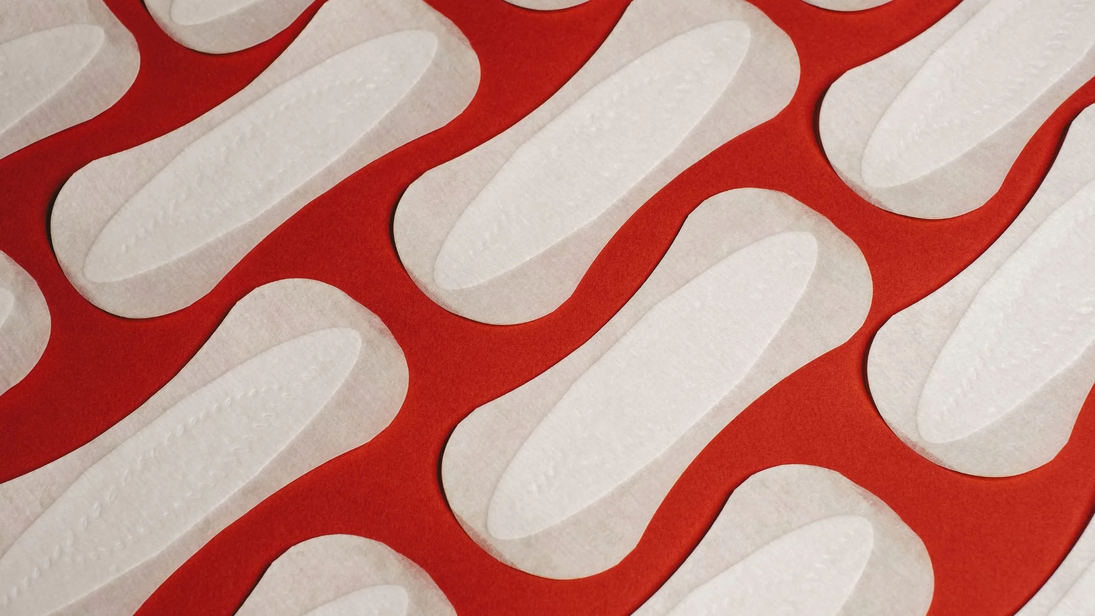 Some sanitary towels on a red background.