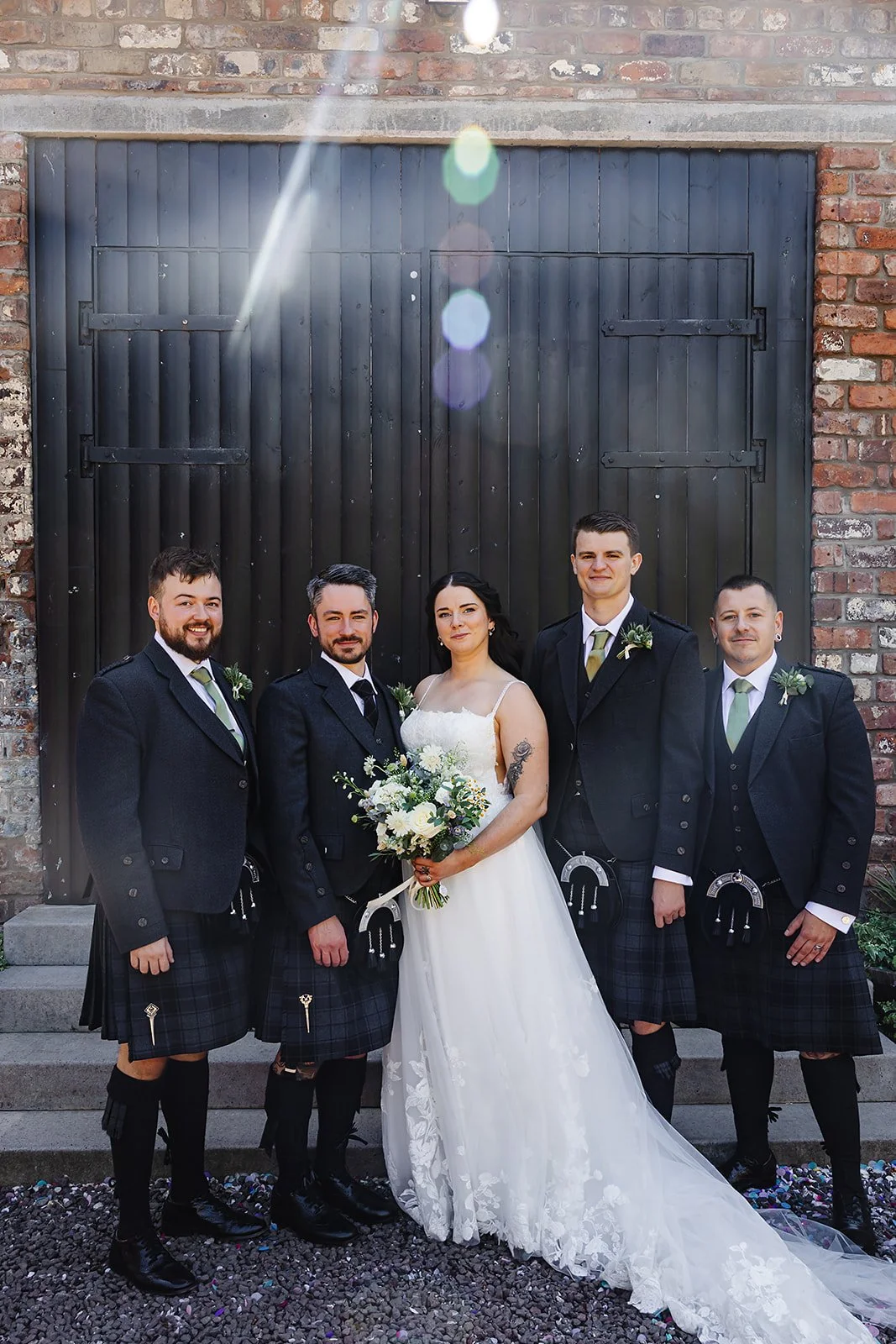 Marie with Oliver and his groomsmen, in the sunshine outside of the The Engine Works, Glasgow.