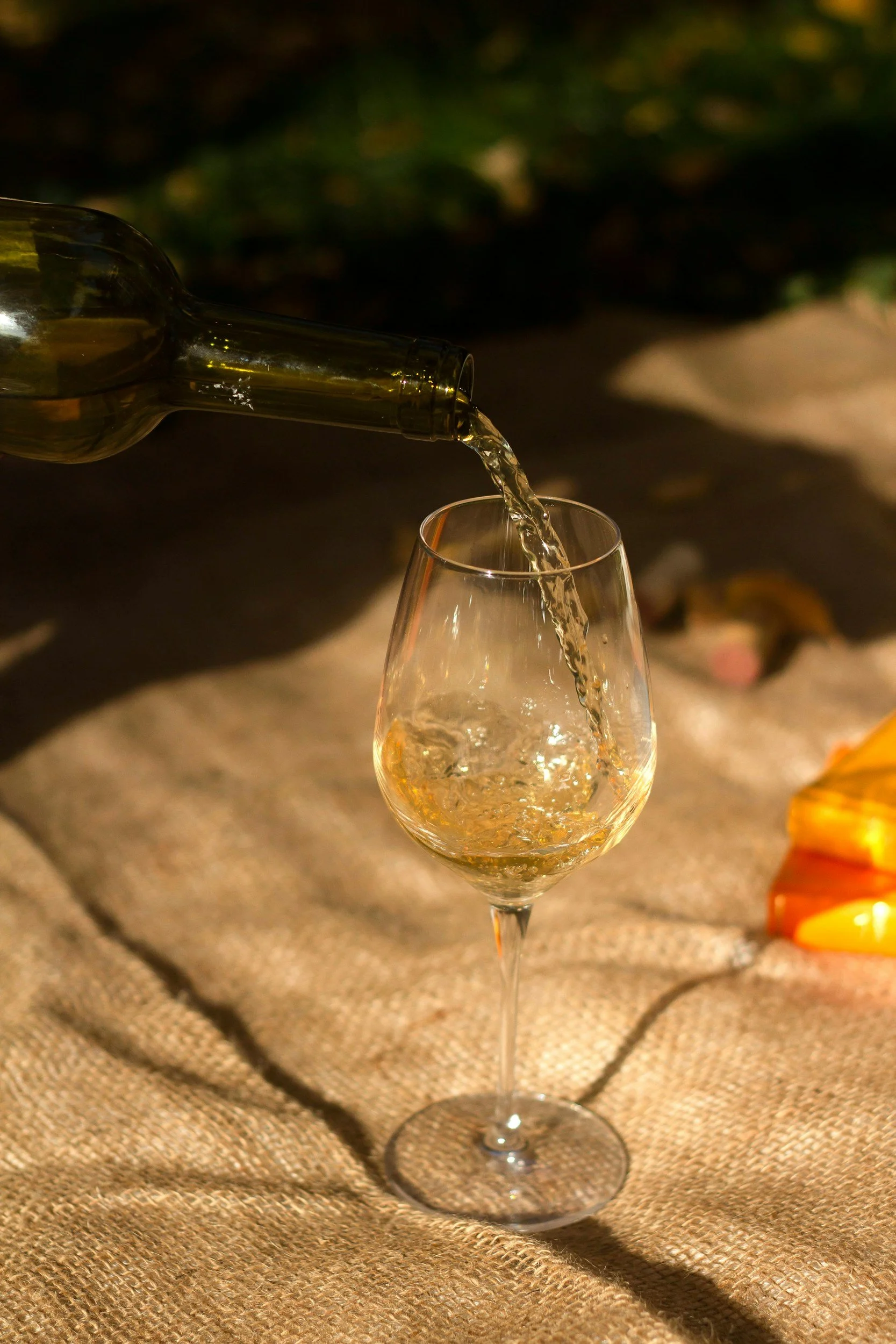 An image of wine being poured into a wine glass.