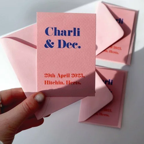 Bold contemporary wedding invitation by Pelirocco Design. Featuring playful typography in blue and orange on soft pink cardstock, this modern minimalist design exudes personality - perfect for design-conscious couples seeking stylish, bespoke station