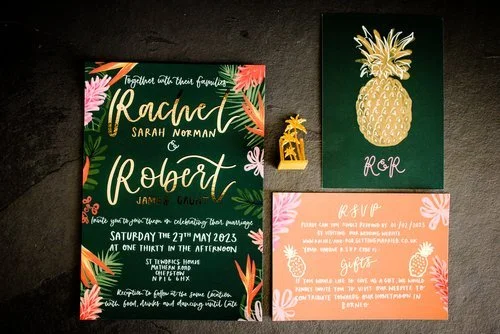 Tropical-themed wedding invitation suite by Bee Davies Illustration. Featuring hand-painted palm leaves, pineapples, and bold calligraphy, this vibrant stationery design captures a fun, exotic vibe - perfect for couples seeking colourful, bespoke wed