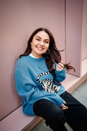 Portrait of Bee Davies, UK-based illustrator and designer known for her bespoke hand-painted wedding jackets, stationery, and murals. Captured in a relaxed setting, this image reflects her creative personality and modern artistic style.