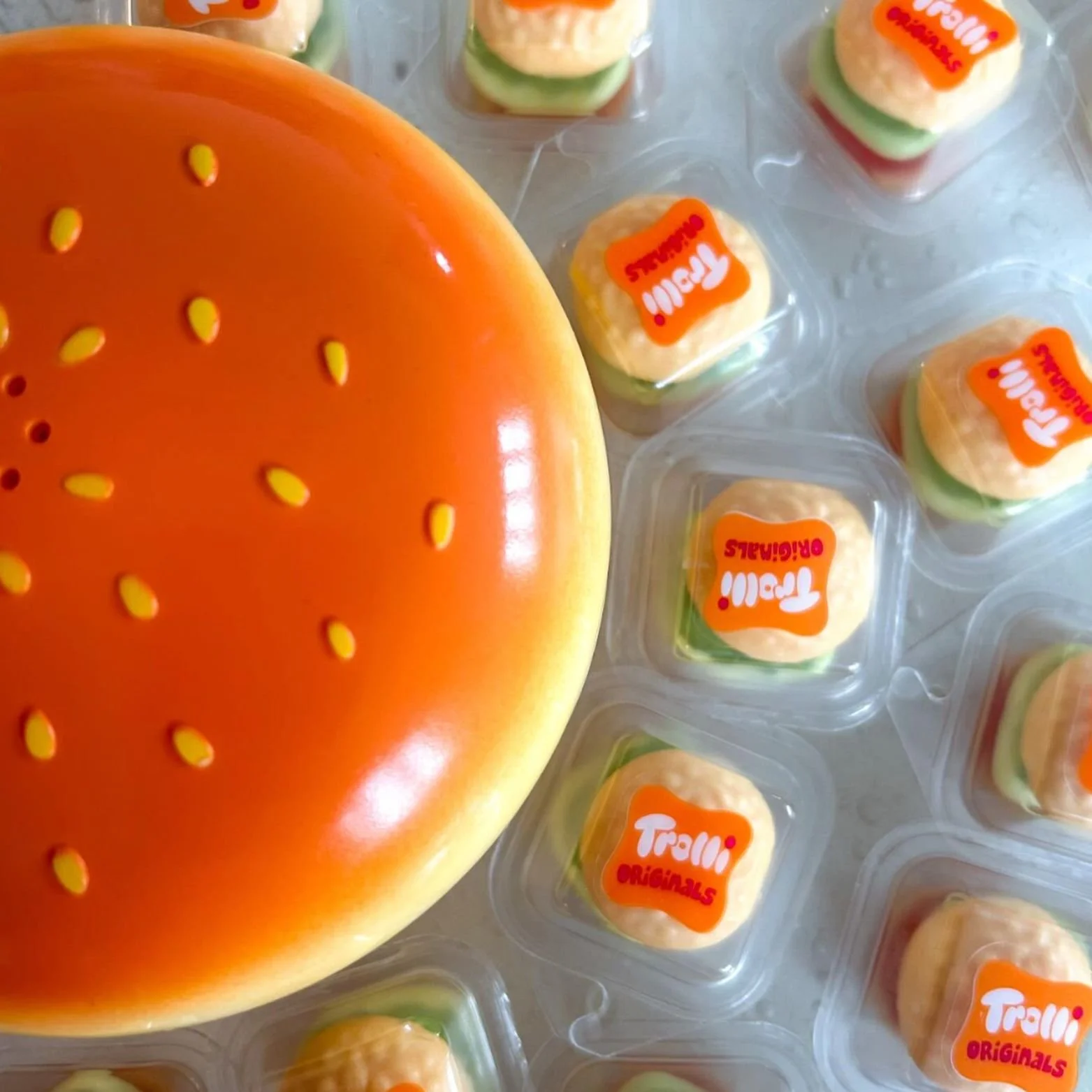 The 'I Just Called To Say' iconic Cheese Burger phone surrounded by little burger sweets.
