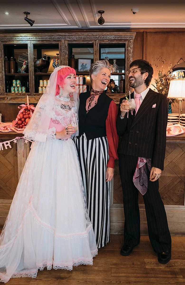 A celebrant shares a laugh with a newly married couple during a relaxed, joy-filled reception moment, reflecting the fun, personality-led ceremonies created by Arabella of A Wilde Celebrant. Joanna Bongard Photography.