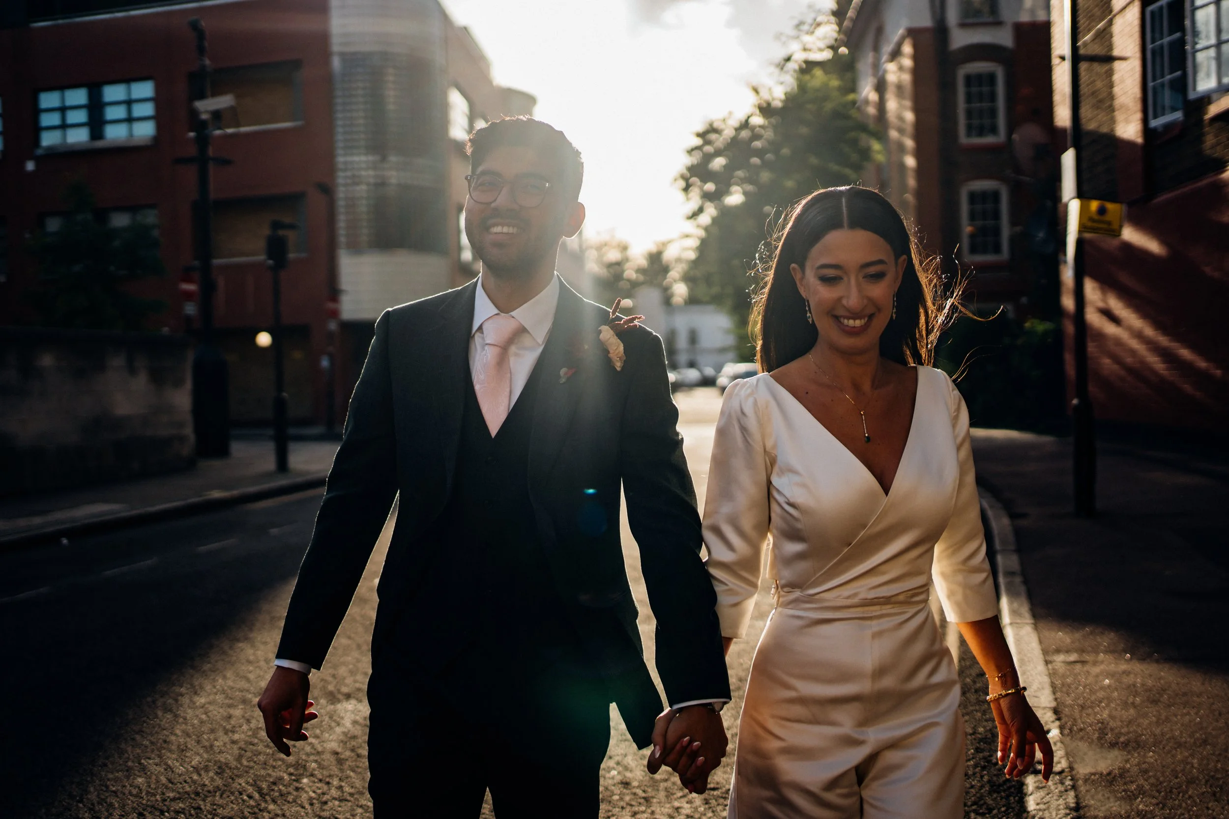 A happy couple holding hands on their wedding day.