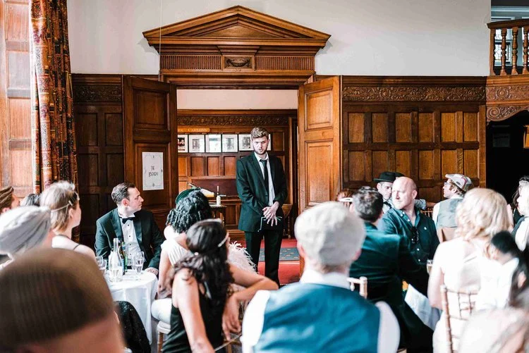 Moonstone Murders interactive wedding entertainment, with a performer in character leading guests through a live-action mystery during the reception.