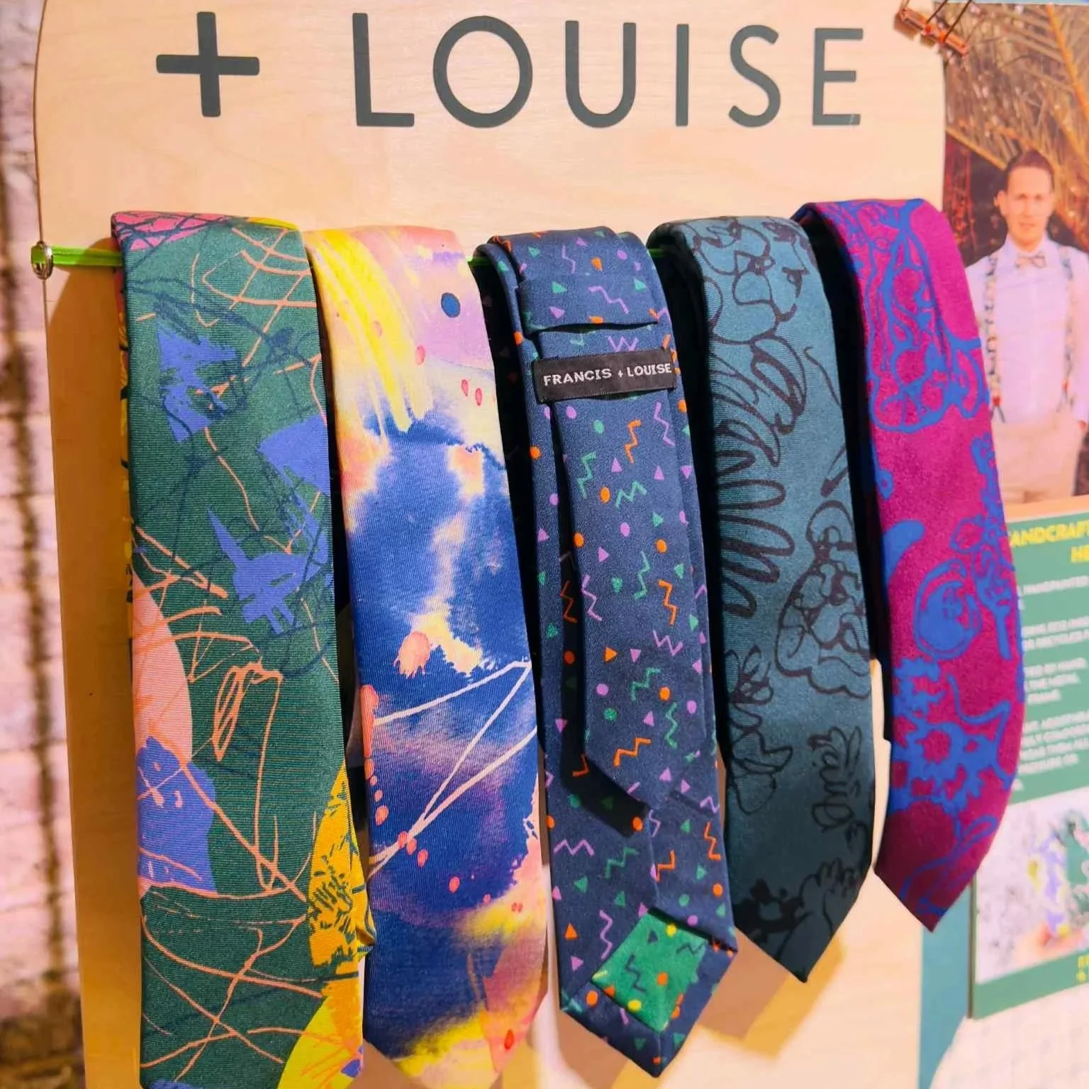 Printed ties hanging on a rack at a wedding fair.