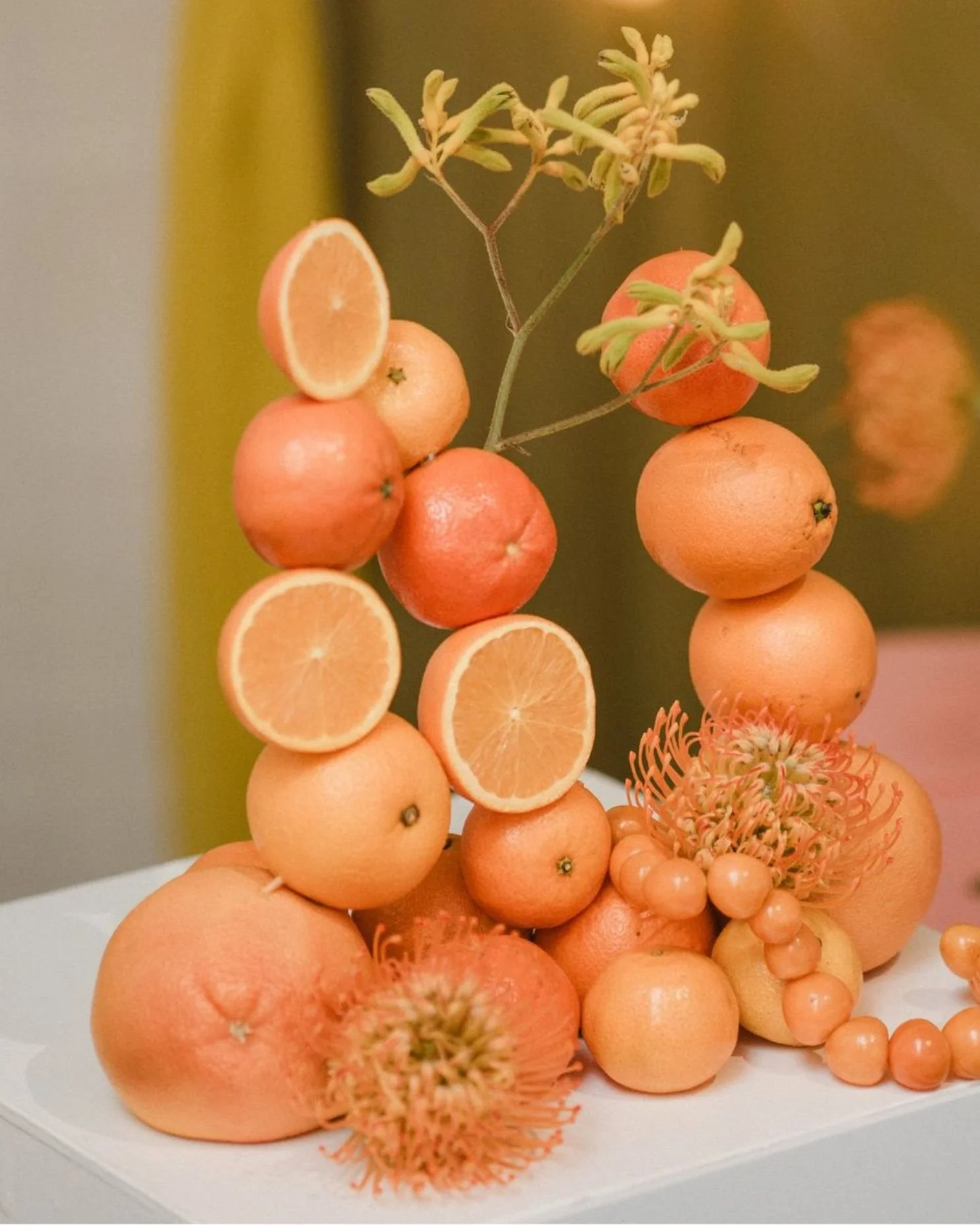 A wedding table centrepiece sculpted with oranges.