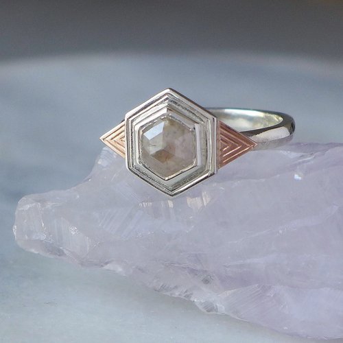 Geometric hexagon diamond engagement ring in silver and rose gold by Daniel Darby Jewellery Designer. Handcrafted in the UK, this art deco-inspired design is perfect for brides seeking a distinctive, modern engagement ring.