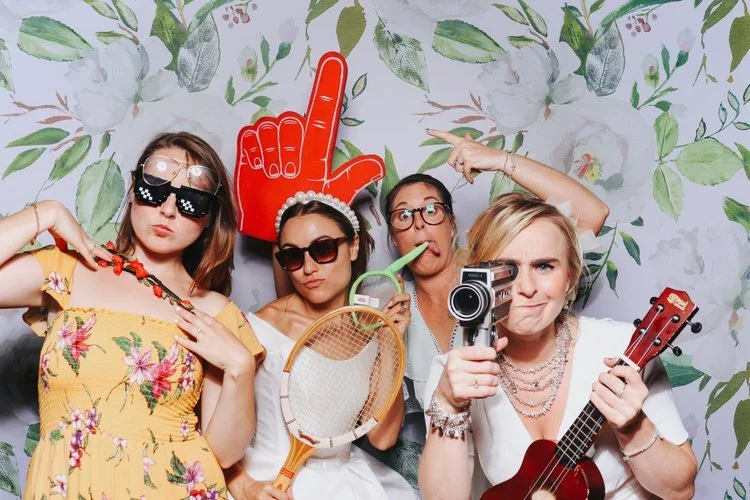 Guests strike their best poses in front of the Flash Fox Photo Booth, complete with fun props, floral backdrops, and plenty of personality. This stylish and entertaining photo booth setup is perfect for weddings across the UK, adding laughter and las