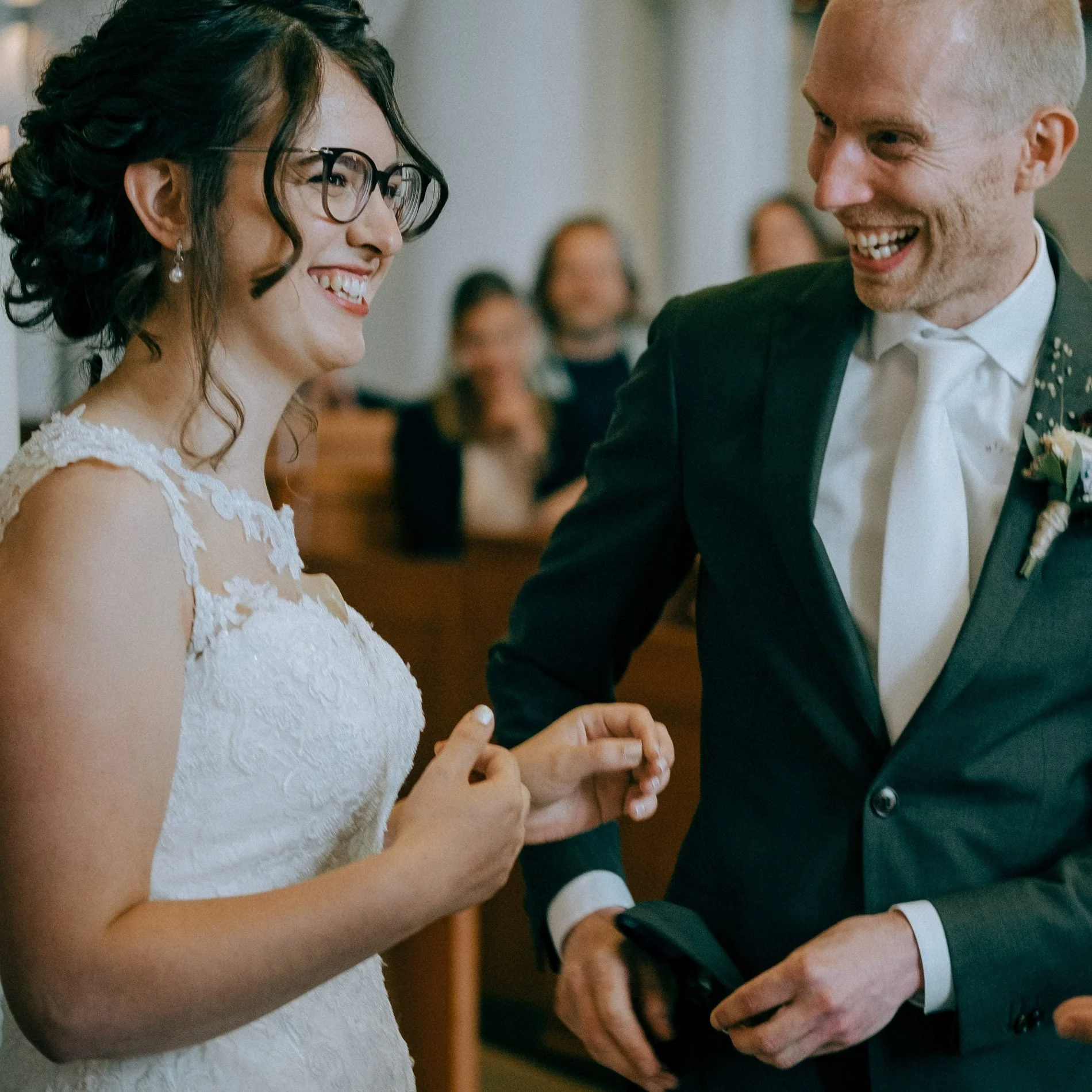 A joyful ceremony moment as the bride and groom laugh together during their vows, captured in a natural, candid style by Quiet Mornings Wedding Photography in Scotland.
