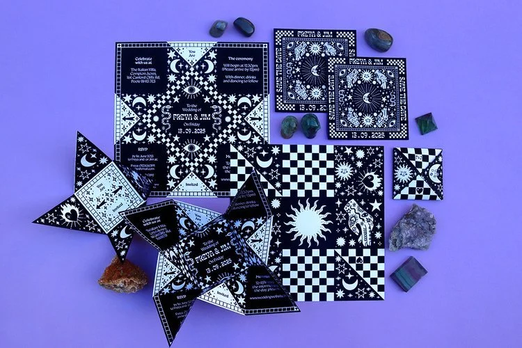 Celestial-inspired wedding stationery suite by Different Day Design Studio, Dorset. Featuring bold black and white checkerboard patterns with sun, moon, and star motifs, this unique invitation set is perfect for couples seeking alternative, mystical 