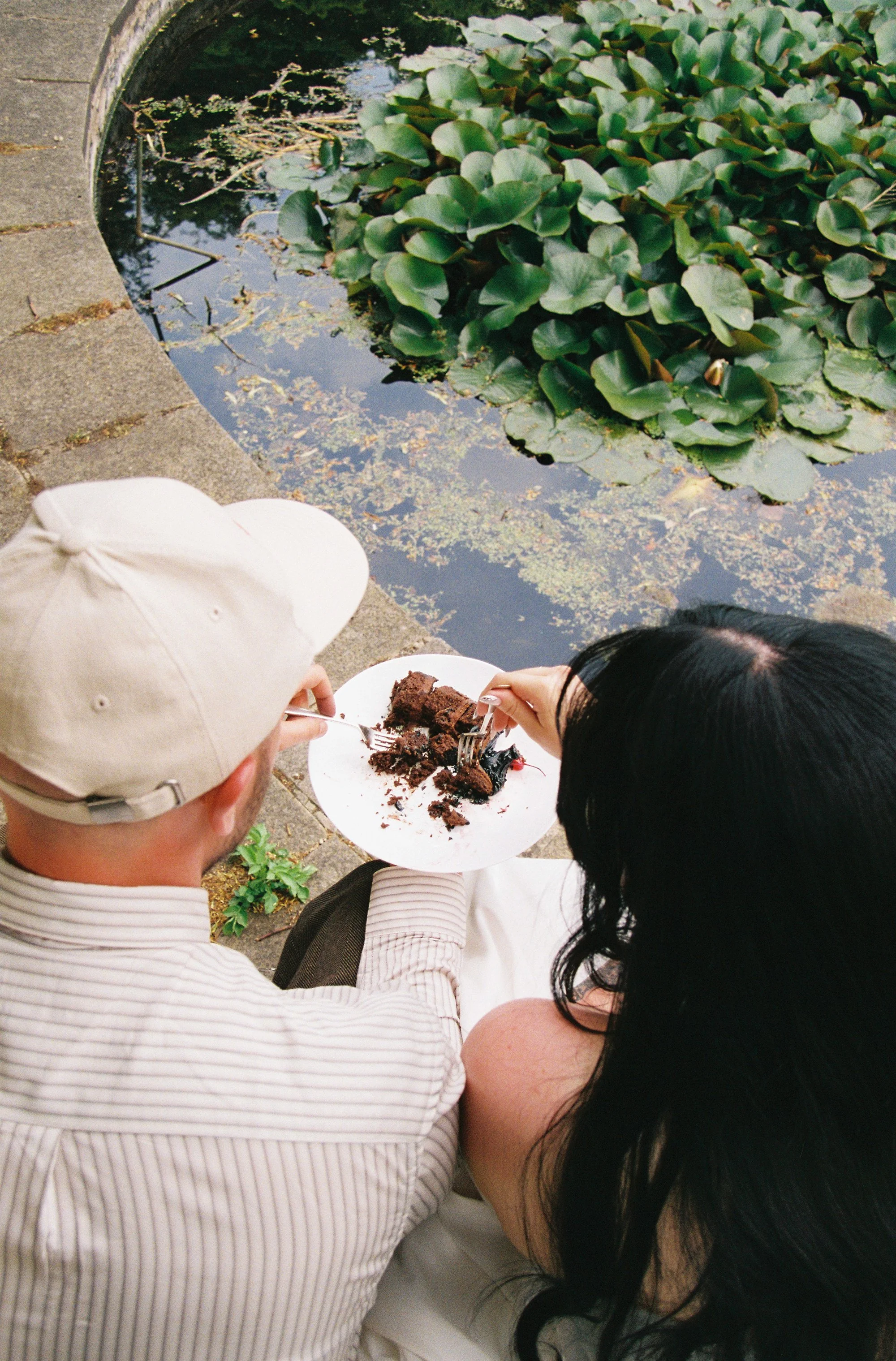 Elizabeth Royse Photography captures weddings with a raw candid energy that feels intimate playful and artfully unpolished shown through grainy film frames of the couple running across sunlit lawns tender close ups of intertwined hands and tattoos sp