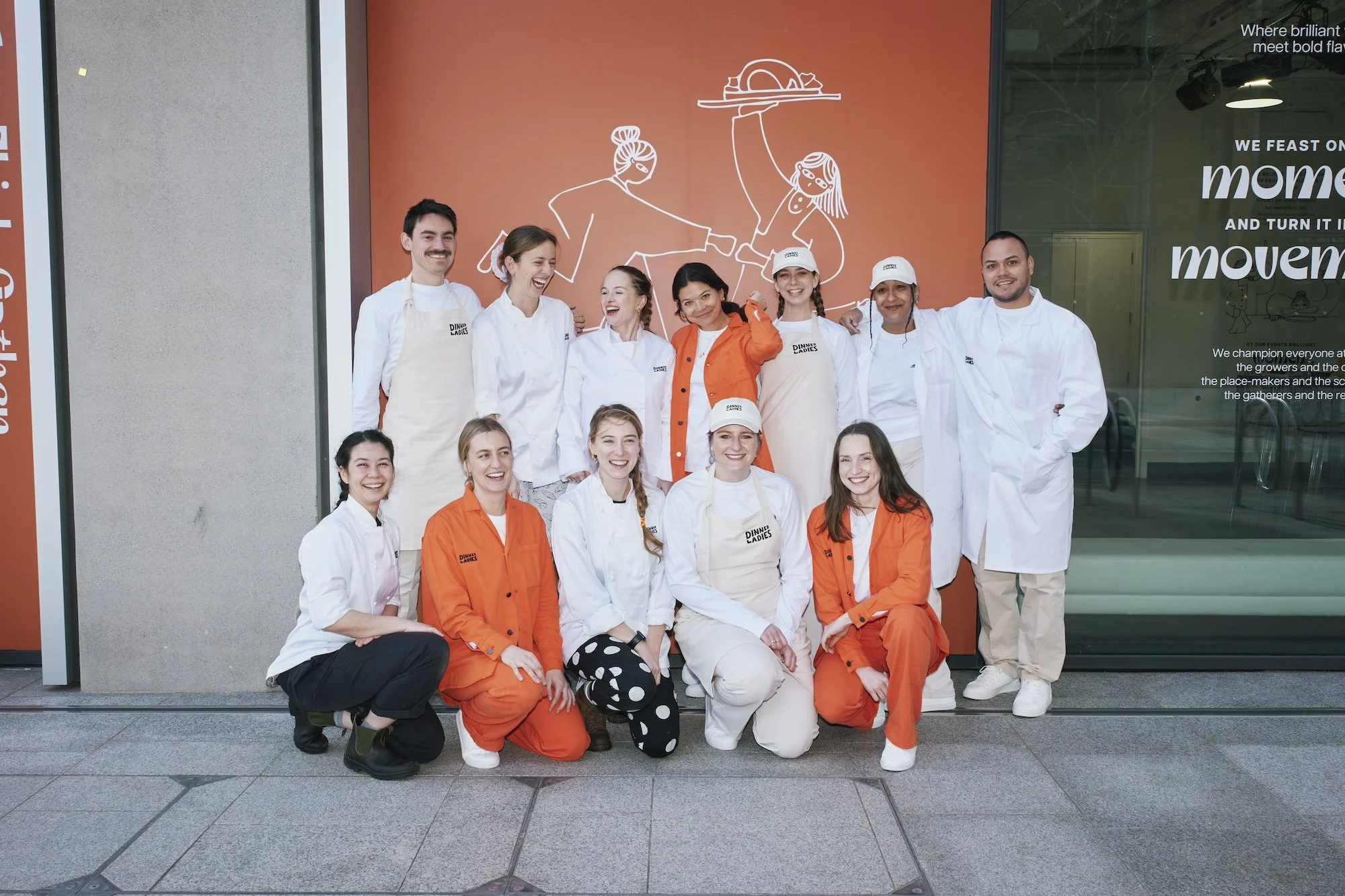 The Dinner Ladies catering team in branded aprons.