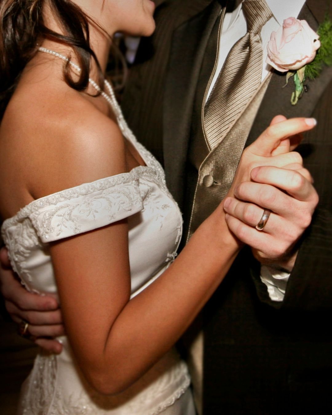 A close up of a bride and groom having a first dance on their wedding day.