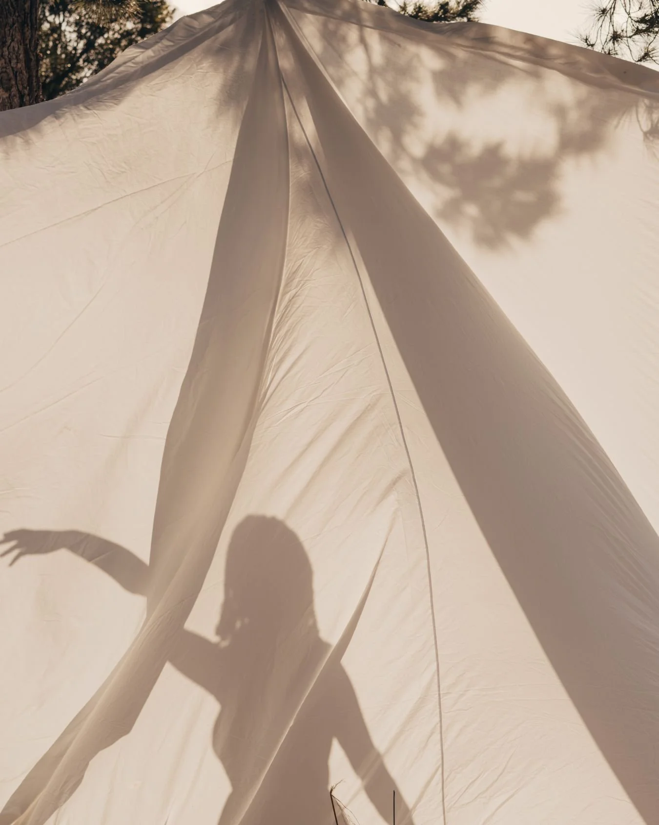 A woman dancing inside a wedding tent.
