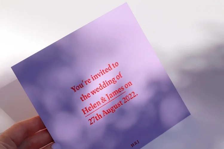 Minimalist lilac wedding invitation by Pelirocco Design. Featuring bold red typography and clean modern styling, this elegant design offers a fresh, contemporary look - perfect for couples seeking simple yet striking wedding stationery crafted in the