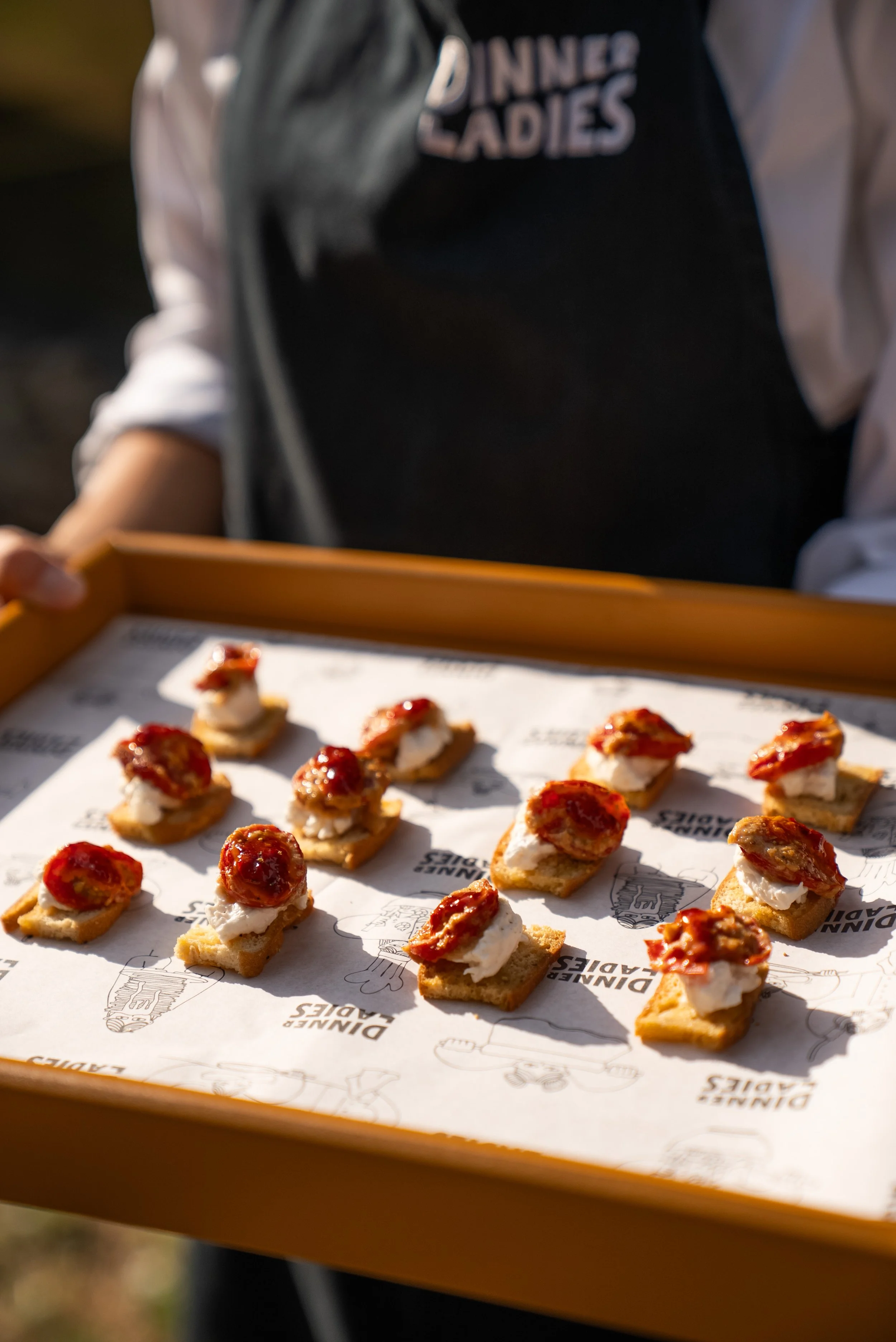 Wedding canapes on branded Dinner ladies paper.