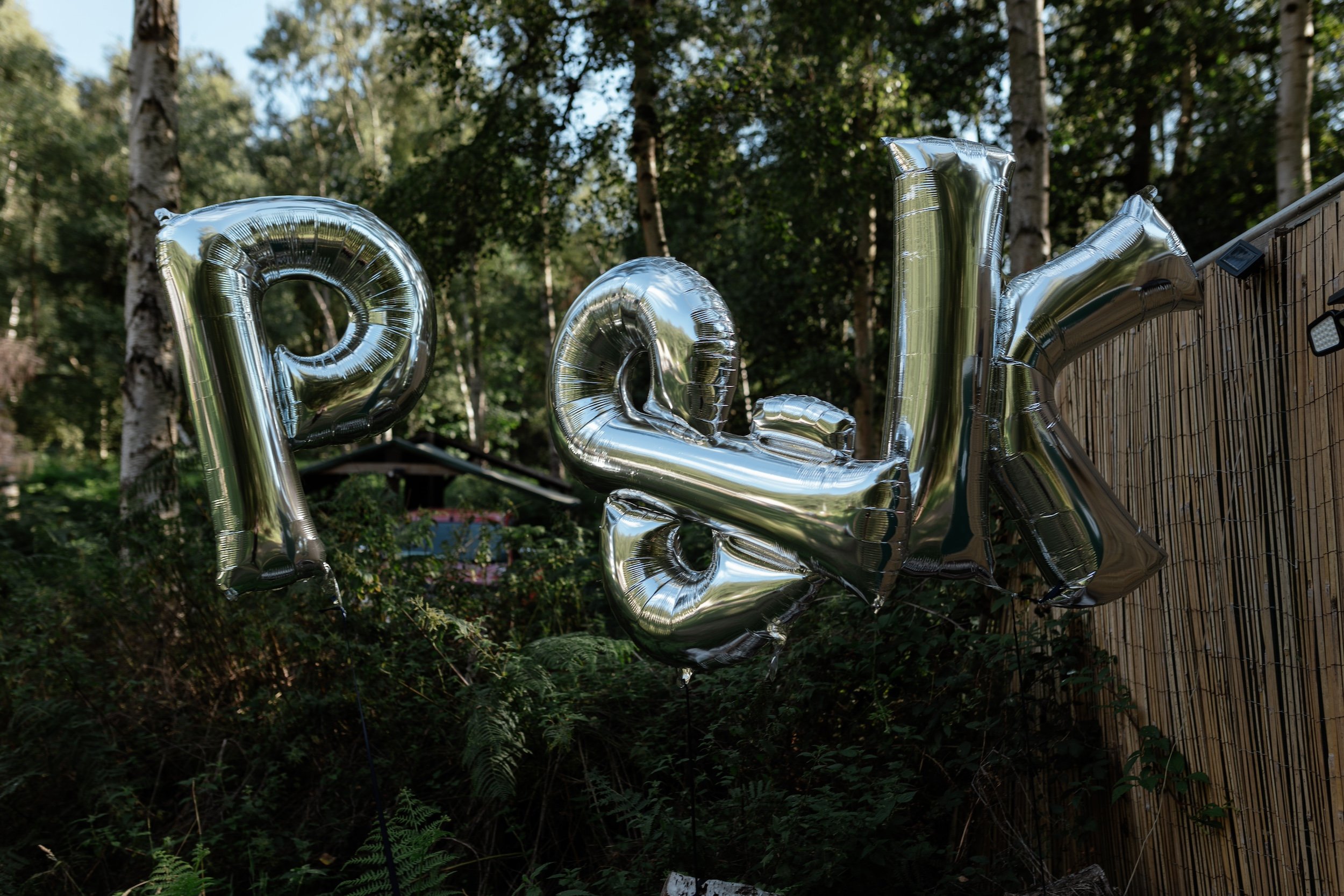 Silver wedding balloons that spell the initiaLs P&K