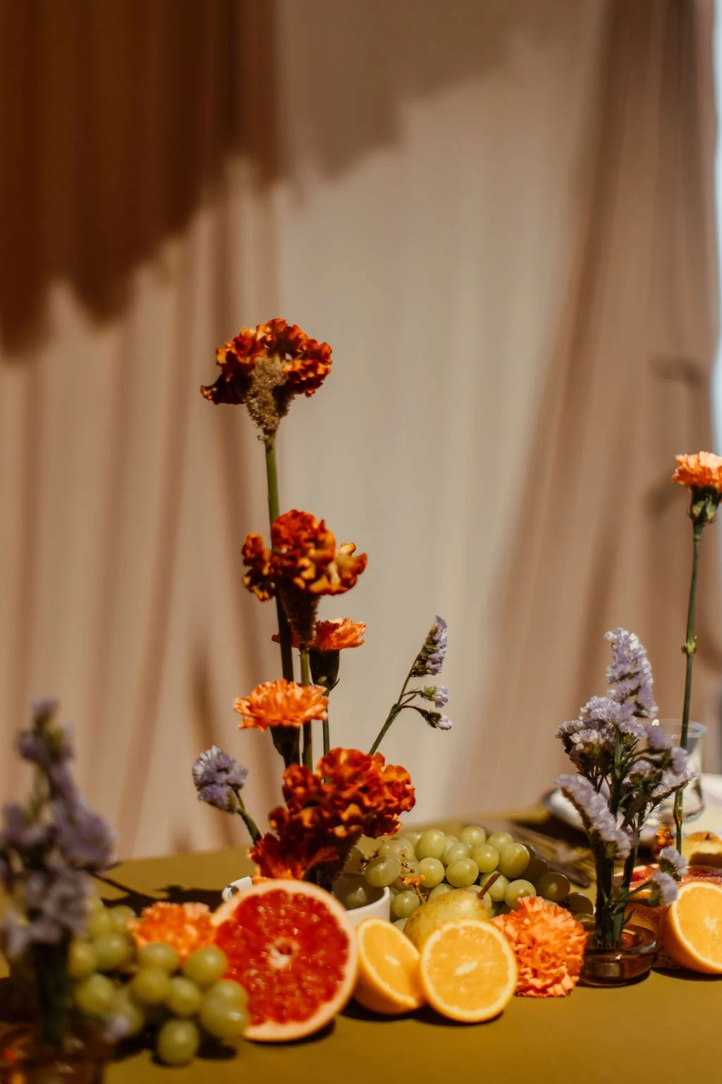 A wedding table that has been styled by Orange Tree Weddings using flowers and fresh fruit.