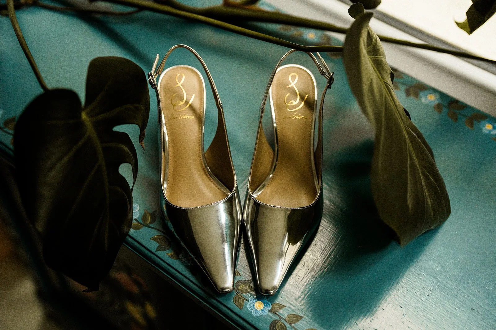 A photo of some silver wedding shoes.