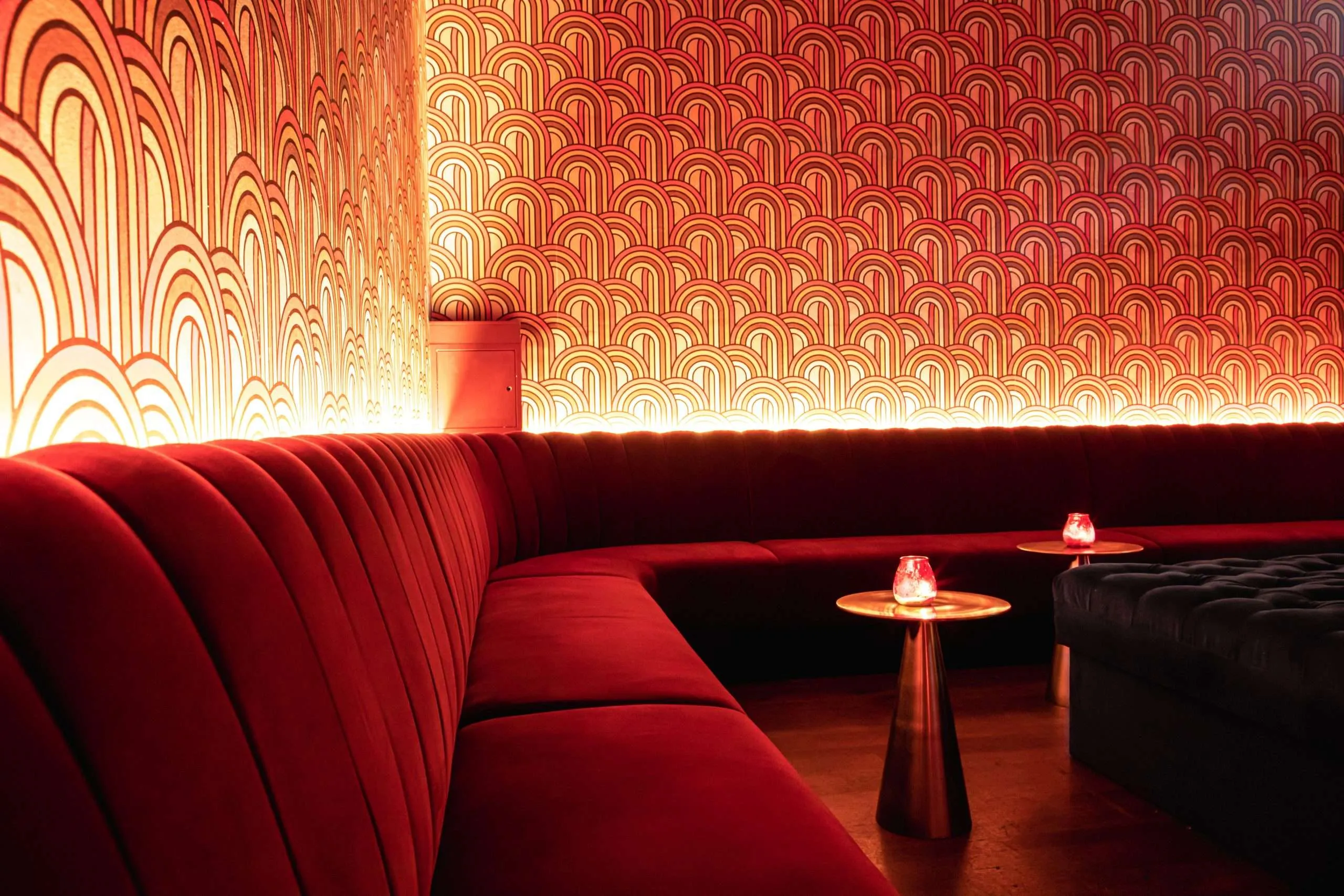 A luxurious red corner sofa at Colours Wedding Venue, Shoreditch.