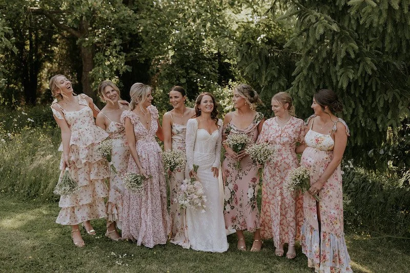 A bride with her bridesmaids, all holding bouquets. Maja Tsolo Photography.