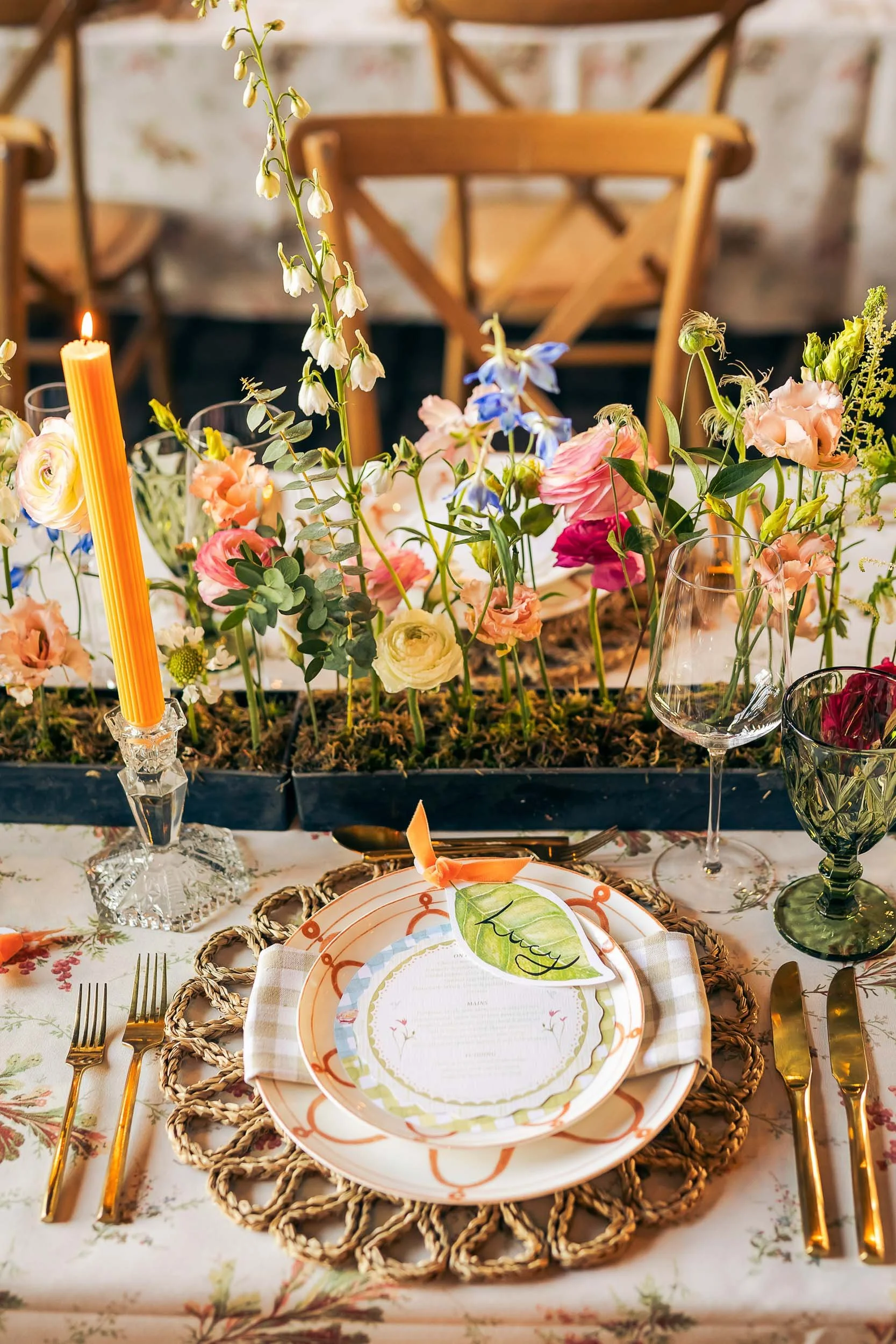 A summery wedding table set up with fresh flowers and candles.