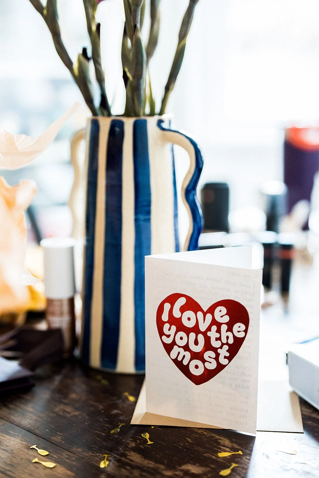 A card with a red heart that says I LOVE YOU THE MOST