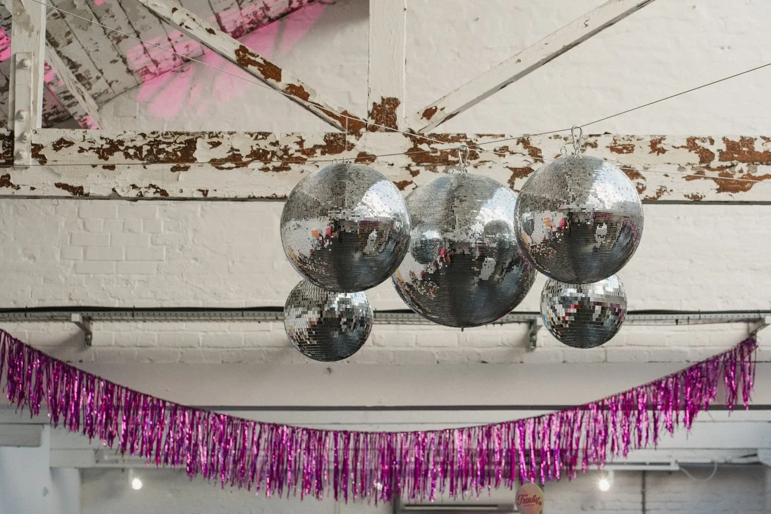 A disco ball and streamer installation by Trashy Decor.