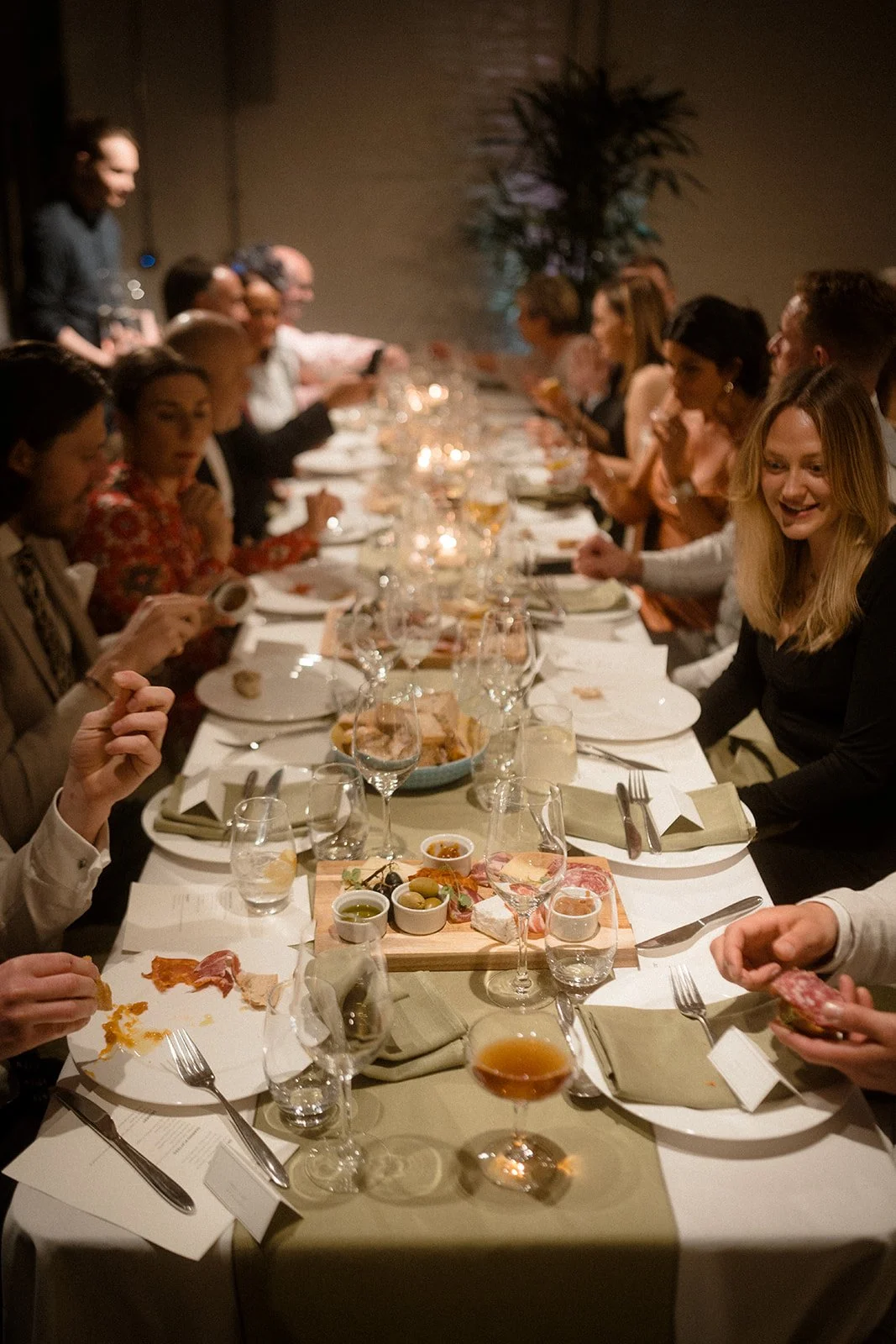 The guests tuck into their wedding dinner, with a selection of breads and cheeses.
